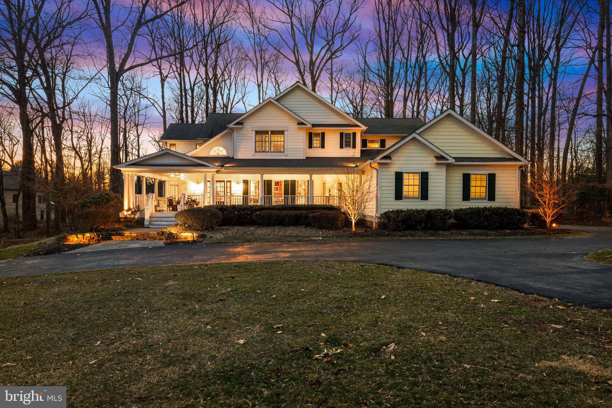 There are some homes that have a certain *feeling*, an atmosphere from the first step over the threshold that inspires visitors with a sense of warmth and welcome. This is one such home! This custom built and designed home exemplifies the "modern farmhouse" style with a stunning wrap-around veranda, multi-gabled roofline and a desirable open-concept floor plan that maintains both formal gathering places and intimate, cozy living spaces. High ceilings and random width solid oak floors carry throughout the main level, allowing effortless transitions from room to room and boasting two handsome fireplaces as focal points in the large expanse of windows that extend across the back of the house.  The solarium addition allows multi-seasonal celebrations (or at-home movie nights) to be spent surrounded by nature with 3 walls of windows; this handsome space has been cleverly designed for easy future main level bedroom suite conversion!  Upstairs, the capacious primary suite has a soaring cathedral ceiling, exquisite built-ins with reading nooks at each window and generously-sized primary bath with dual walk-ins and Jacuzzi tub.  The walk-out lower level offers sizeable, flexible rec space with game and exercise rooms plus full bath and storage space galore. No matter where you are in this delightful home, you'll find the spaces filled with an abundance of light, warmth and charm!