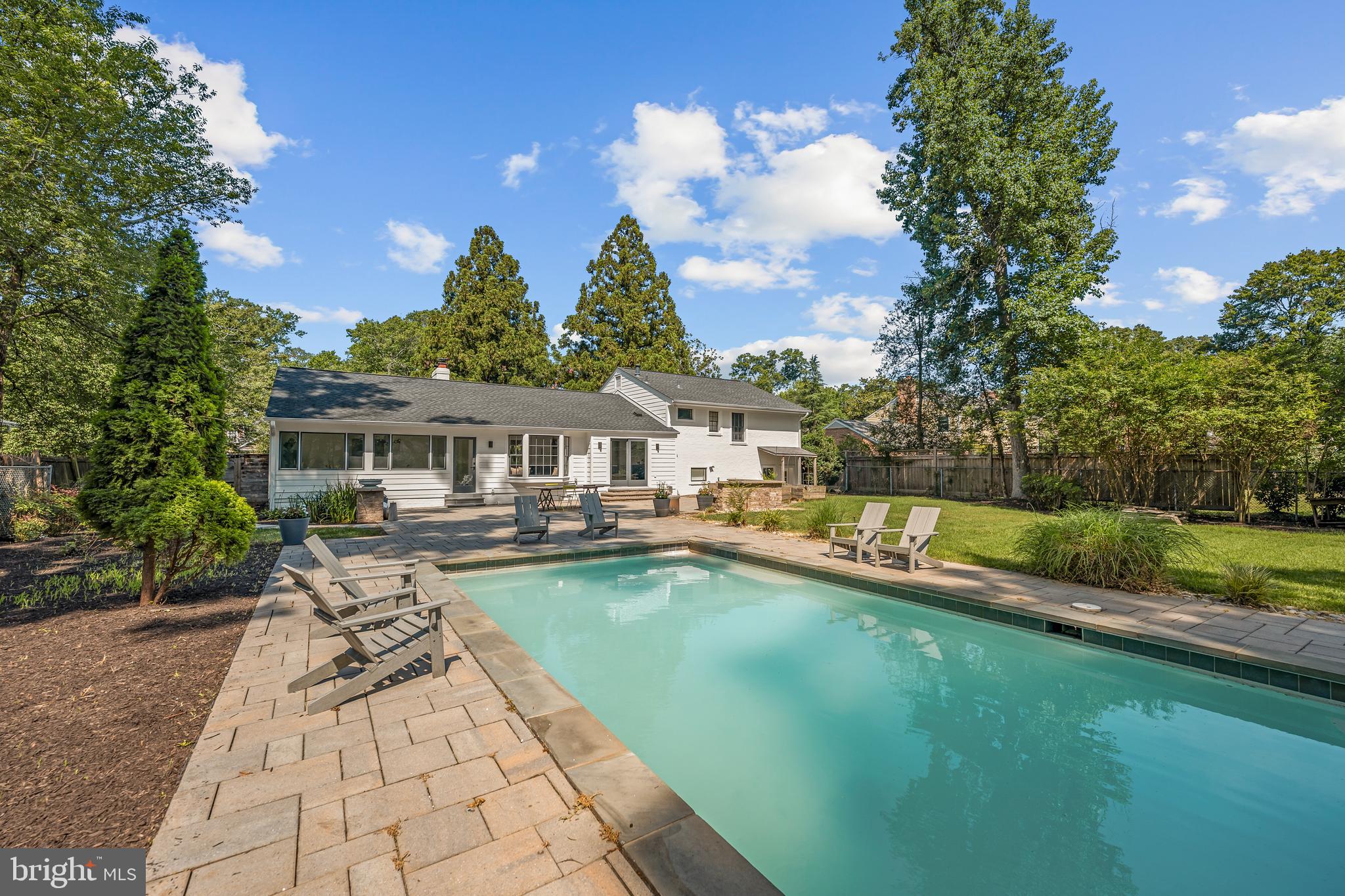 Welcome home! Tucked away in a private, peaceful setting, this four-level home invites you to unwind by your own sparkling backyard pool while offering plenty of space to entertain both inside and out. Gleaming hardwood floors and an abundance of natural light welcome you into a beautifully renovated kitchen, where sleek quartz countertops and newer stainless steel appliances create a chef's dream, complete with a large gas range and electric oven (2019), a pot filler ready to make cooking a breeze, professional-grade hood exhaust, and an ultra-quiet dishwasher (2022). An oversized island breakfast bar sits beneath a stunning bay window, with a built-in dog station featuring a water faucet and drain, perfect for larger dogs. The adjacent formal dining room offers an elegant space for hosting memorable gatherings, while the living room's large picture window and wood burning fireplace add even more warmth and charm to the main level. Upstairs, the primary bedroom suite is a true retreat, featuring a private sitting room ideal as a home office, nursery, or whatever suits your needs, along with an updated en suite bathroom. A second bedroom and full bathroom complete this level. Downstairs, one level below the main floor, two more bedrooms share a full bathroom, along with a spacious laundry and storage room with washer and dryer (2023). Below that, a versatile recreation room and a flexible bonus room offer even more room to spread out, ideal for a home gym or playroom. Outside, mature trees provide peaceful shade over a lush, expansive lawn, while the heated saltwater pool and extensive stone patio with built-in benches create the perfect setting for relaxing or entertaining within a fully fenced backyard. Parking is a breeze with a 2-car garage and driveway, complemented by a full, usable attic offering incredible additional storage space. Recent updates including a new roof and siding (2020), furnace (2022), HVAC system (2023), and a whole-house fan that can be used in the spring and fall to naturally cool the home and reduce reliance on AC bring added peace of mind. This peaceful community backs to the natural beauty of Fort Hunt National Park, offering easy access to scenic picnic areas and the Potomac River Trail, all while keeping you conveniently connected to everyday life. Just minutes to Safeway, Walmart, Old Town Alexandria, National Harbor, Huntley Meadows Park, Mount Vernon, and Fort Belvoir. Quick access to GW Parkway, Route 1, I-495, and I-95 makes commuting a breeze. Schedule a private tour of your beautiful new home today!
