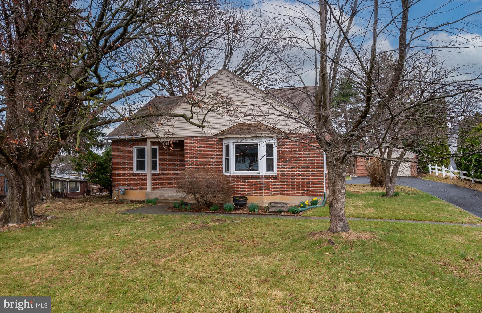 Ready and waiting for you!  This red brick beauty in the borough of Kutztown is available to move in as soon as you can.  As you step inside everyone will love the hardwood floors on both levels.  Great space throughout including living room accented by bench window seat, the perfect place to watch the afternoon go by.  Big kitchen can accommodate any gathering.  Lots of countertop space including breakfast bar for your morning coffee or little ones homework.  Plenty of room of your favorite hutch and kitchen table too.  Kitchen has laundry hook ups so you can multi-task with ease. Two first floor bedrooms along with updated full bathroom complete your main floor living.  Upstairs you will find two more spacious bedrooms, both with walk-in closets.  Inside one closet you will find a door to attic space which offers extra room for a future bathroom. Updated wiring throughout the second floor and newer lighting give you comfort and peace of mind.  Neutral tones throughout both levels offer a bright blank canvas for your personality to come through.    Full HEATED basement provides you more room for entertainment and storage.  New GAS heater in 2023 along with replacement windows throughout keeps you monthly budget in check.  Great backyard includes covered patio perfect for relaxing or entertaining loved ones.  20 x 25 garage gives you extra storage.  Plenty of additional parking and turnaround space.  Awesome Kutztown borough location is walkable to many intown attractions including park, pool, and school.  Your new beginnings start here.  Welcome home!