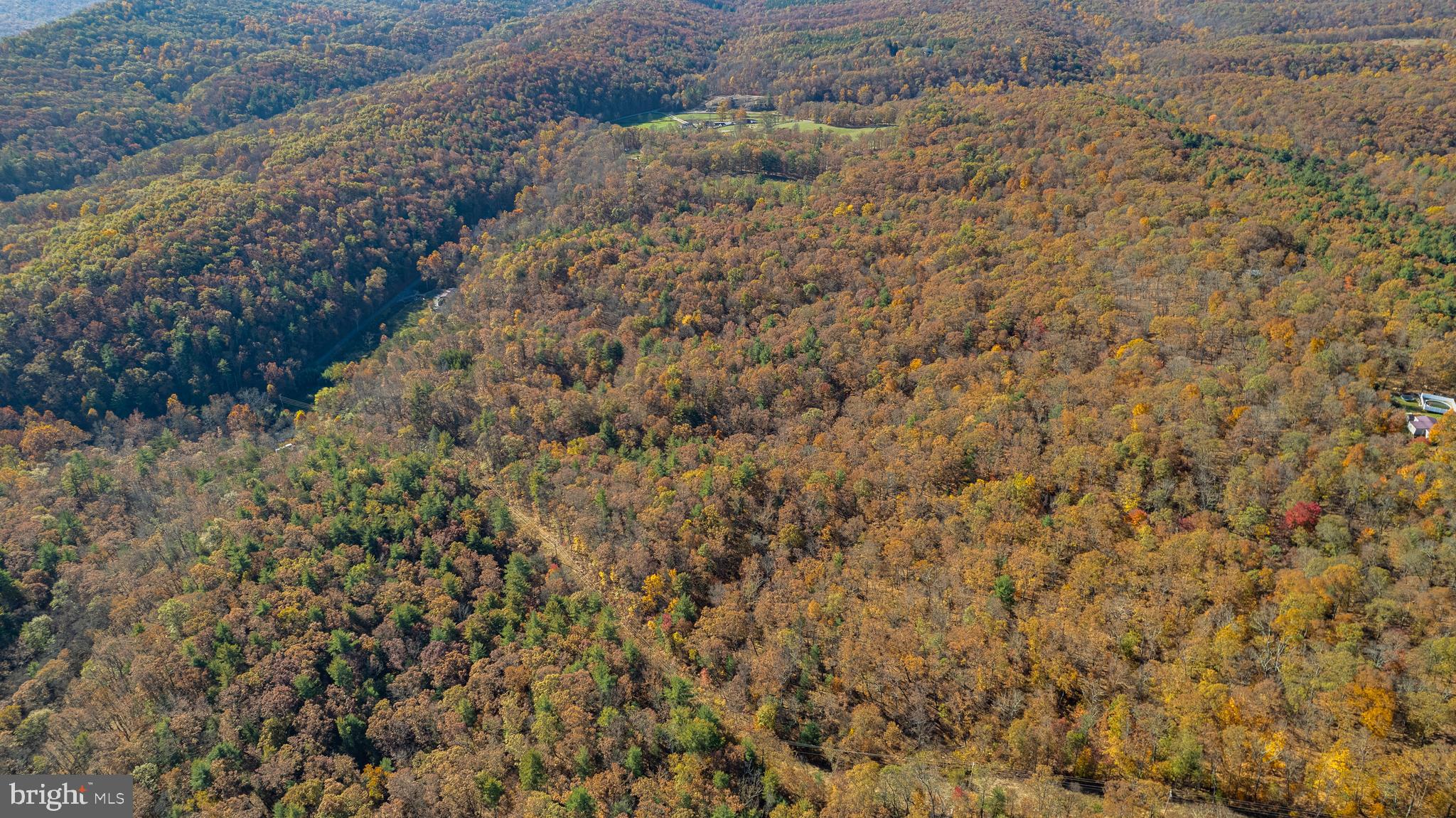 Discover nearly 18 acres of Unrestricted land in Wild, Wonderful, WV. Situated just off a state-maintained road, this land is both accessible and secluded – perfect for hunting, enjoying the outdoors or creating a peaceful retreat. You’ll see that there is electric nearby, along with a small shed and one well located just beside the shed. The terrain is mostly sloping which provides a sense of privacy, seclusion and natural beauty -- perfect for hunting or simply enjoying the outdoors. Across Youngblood Road, a small, level portion of the land awaits your creativity. Here you’ll find an older cabin shell on a slab foundation, along with another well – a great starting point for a hunting cabin or peaceful getaway.  A deeded easement traverses the property, offering access to neighboring parcels.