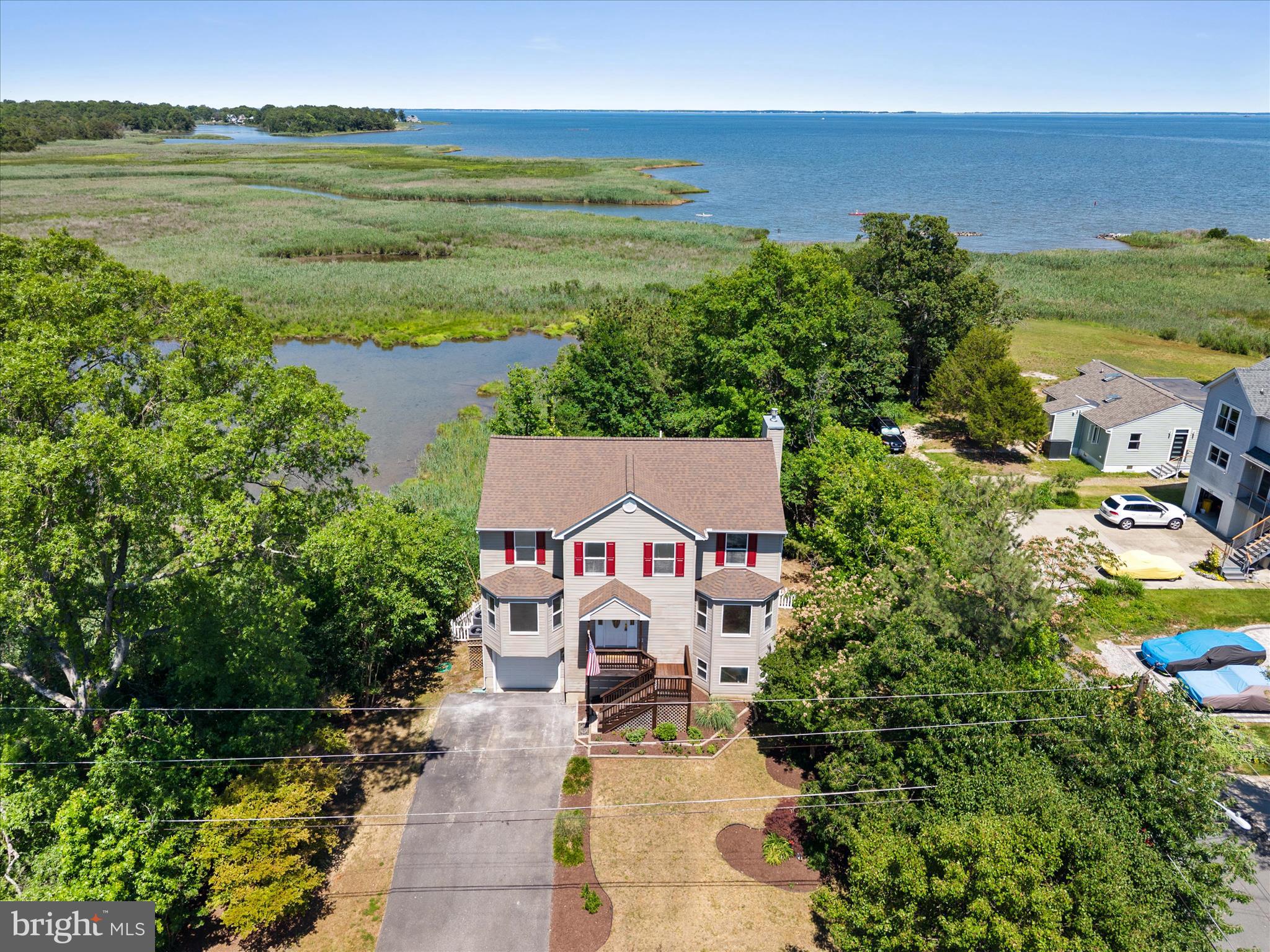 Discover the ultimate Chesapeake Bay waterfront lifestyle in this beautifully appointed 4-bedroom, 3-bath residence, where breathtaking water views and thoughtful design create an exceptional coastal retreat. Perfectly positioned to capture panoramic bay vistas, this home offers an elegant blend of comfort, sophistication, and year-round waterfront living. The kitchen serves as the centerpiece of the home, featuring seamless flow into the open-concept living spaces. A spacious dining room provides the perfect setting for holiday gatherings, intimate dinner parties, and memorable celebrations with family and friends. The light-filled living room showcases stunning water views and a cozy fireplace for cooler evenings; and opens to an expansive deck, creating a seamless connection between indoor and outdoor living. Designed with convenience in mind, the main level includes a bedroom, full bath, and laundry area, offering the option for first-floor living or comfortable accommodations for guests. Upstairs, the private primary suite serves as a peaceful sanctuary, complete with an en suite bath and direct access to a private waterfront deck where you can enjoy morning coffee, spectacular sunrises, and endless views of the bay. Two additional bedrooms and a full bath provide ample space for family and visitors. The lower level features two garages, ideal for hobbies, projects, storage, or future customization. Outside, multiple deck spaces invite you to relax, entertain, and immerse yourself in the beauty of the Chesapeake Bay. Spend your days boating, fishing, kayaking, paddleboarding, or simply enjoying the tranquil waterfront setting from the comfort of home. Whether you're seeking a luxurious year-round residence or an exceptional waterfront getaway, this remarkable property offers a rare opportunity to experience the very best of Chesapeake Bay living.  All set within the stunning town of Churchton with the water front park, a playpark and lovely water front walking paths; this is truly a peaceful and gorgeous place to be!