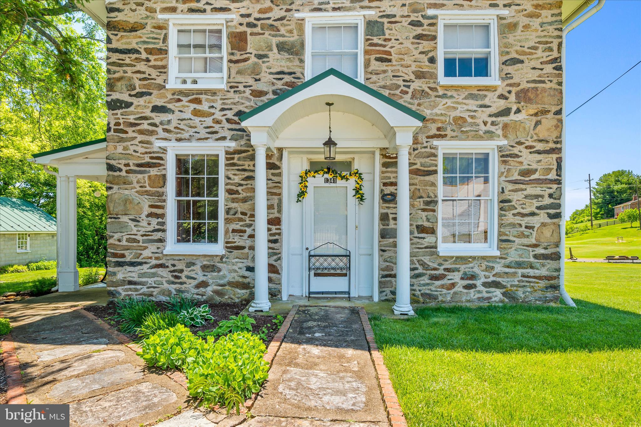 Few homes offer the opportunity to own a piece of local history. Originally constructed circa 1840 as the Petersville Meeting House and recognized by the Frederick County historical society as House No. 401, this remarkable stone cottage has been lovingly preserved while thoughtfully updated for modern living.

Nestled among the rolling farmland and peaceful countryside of western Frederick County, this unique property offers a rare blend of history, charm, and convenience, located just minutes from the Jefferson MARC train station. Included in the sale are two lots totaling approximately 0.51 acres, creating a picturesque setting that feels worlds away while remaining accessible to commuter routes and everyday amenities.

Serviced by a 3-bedroom septic system, the home offers three official bedrooms along with an additional room and full bath on the main level, providing flexible space for a home office, den, library, guest space, or other uses to suit your needs. Designed long before modern builders mastered efficient use of space, this home showcases thoughtful craftsmanship throughout, with abundant storage, charming architectural details, and even walk-in closets. 

The home’s historic character remains beautifully intact. Recognized by the local historical society, exterior improvements have been thoughtfully completed with historical approval to preserve the property’s significance and architectural integrity. The original windows have been carefully maintained and enhanced with storm windows and additional interior protection, offering improved comfort while honoring the home’s historic design.

Pride of ownership is evident in every corner of this property. Both the metal roof and HVAC system are only two years old, providing modern efficiency and peace of mind. The home also features 200-amp electric service, well and septic systems replaced by Frederick County in 2013 with records available, and a water treatment system complete with filtration and UV purification.

Outside, beautifully landscaped grounds complement the timeless appeal of the home. A peaceful side porch, currently the owners’ preferred entrance, provides the perfect place to enjoy a morning cup of coffee, relax with a good book, or simply take in the quiet beauty of the surrounding farmland.

The detached block garage offers exceptional storage, workshop, hobby, or equipment space. While the current garage door opening does accommodate vehicle entry, it is not with standard Garage doors,  the structure provides substantial usable square footage and versatility.

Even the basement reflects the exceptional care this home has received throughout the years. Clean, dry, and meticulously maintained, it features a professionally installed French drain system, sump pump, and neatly organized mechanical systems.

Properties of this caliber and historical significance seldom become available. From its fascinating origins and enduring stone construction to its thoughtful updates and remarkable condition, this is a home that must be experienced in person to fully appreciate. Every room tells a story, and every detail reflects generations of stewardship, preservation, and pride.