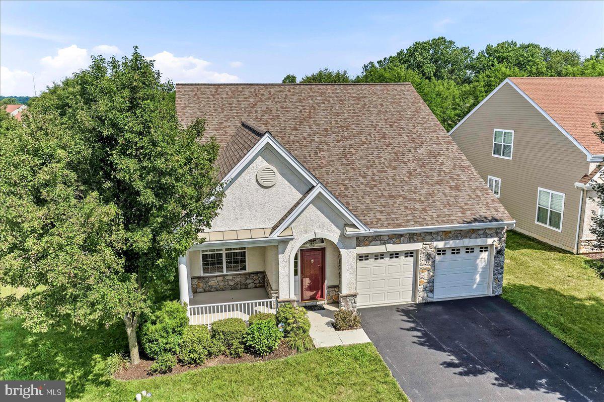 Welcome to Ovations at Elk View, one of Southern Chester County’s premier active adult lifestyle communities, where exceptional living, convenience and a vibrant social lifestyle come together. If you’ve been considering downsizing but aren’t ready to give up the space you love, this exceptional home offers the perfect opportunity to right size without compromise.
Perfectly positioned on a premium lot backing to mature trees and open space, this beautifully maintained 3 bedroom, 3 full bath home offers a rare combination of privacy, spacious living and low maintenance convenience. Freshly painted throughout with brand new carpeting, this turnkey home is vacant and ready for immediate occupancy. 
A charming covered front porch welcomes you into the hardwood foyer featuring vaulted ceilings and an art niche.. The elegant dining room is highlighted by a double tray ceiling, crown molding and chair rail, creating the perfect setting for holidays and special occasions.
The well appointed kitchen features upgraded cabinetry, stainless steel appliances, recessed lighting, a center island, pantry and hardwood flooring. The kitchen flows seamlessly into the expansive breakfast area and the expanded family rooms, where soaring vaulted ceilings, a gas fireplace flanked by illuminated custom built-ins and sliding doors to the composite deck create an inviting space for everyday living and effortless entertaining. A retractable awning overlooks mature trees and open space, providing one of the community’s more private backyard settings.
Privately situated on the main level, the spacious primary suite is accessed through a gorgeous arched entry with decorative columns and offers a tray ceiling with recessed lighting, a sitting area with vaulted ceiling and ceiling fan, private access to the composite deck, a walk in closet and an ensuite bath featuring a dual vanity, soaking tub and beautifully tiled walk in shower.
A second bedroom, full hall bath, main floor laundry, coat closet and oversized two car garage complete the first level.
A beautiful hardwood staircase leads to the upper level offering exceptional flexibility with a spacious loft overlooking the family room below, a third bedroom, full bath and generous storage. 
Additional highlights include a New Architectural Shingled Roof (2019), New Lennox Elite natural gas furnace (2018) New AC in (2024) and public water and sewer. Life at Ovations at Elk View extends well beyond your front door. The HOA maintains the lawn, snow removal and trash.  Residents enjoy an award recognized clubhouse with a fitness center, sauna, library, gathering spaces and game rooms, along with a resort style swimming pool, pickleball and tennis courts, indoor and outdoor bocce, shuffleboard, putting green and a full calendar of clubs, activities and social events. The community has earned the prestigious  Gold Star Community designation, recognizing excellence in community governance and management.

Ideally located just minutes from Routes 1, 896 and 796, with convenient access to Kennett Square, Delaware and Maryland, you'll enjoy easy access to grocery shopping, pharmacies, healthcare, restaurants and everyday conveniences. This exceptional home offers the perfect blend of comfort and carefree living, allowing you to embrace a maintenance free lifestyle without sacrificing the space, quality and flexibility you've always enjoyed.