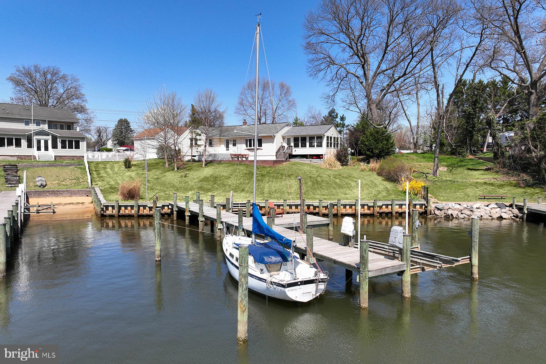 BACK ON THE MARKET AND SHOW-READY CONDITION!
Welcome to effortless one-level living on a beautifully landscaped ⅓-acre lot with 85 feet of prime waterfront on Rock Creek. Watch the sunset over the water from your bay window, sunroom, or waterside patio — this home is all about capturing the view. The owners re-built the bulkhead and pier, and it’s an easy ride out to the Chesapeake Bay. The multi-slip pier has 8 ft water depth.
Inside, you’ll find 3 bedrooms and 2 full baths, including a primary suite with lovely water views and a private ensuite bathroom. The living room features a cozy gas fireplace and that same stunning view, plus direct access to the patio for seamless indoor-outdoor living. A fabulous sunroom offers flexible space; it’s the perfect family room, dining area or take part of the space for your home office. This is the room where you’ll want to spend your time! 
Downstairs, the unfinished basement provides outside access, a workbench for weekend projects, and ample storage for water toys or gear. Whether you're looking for your forever home or a weekend getaway, this home offers the waterfront lifestyle with comfort and charm.