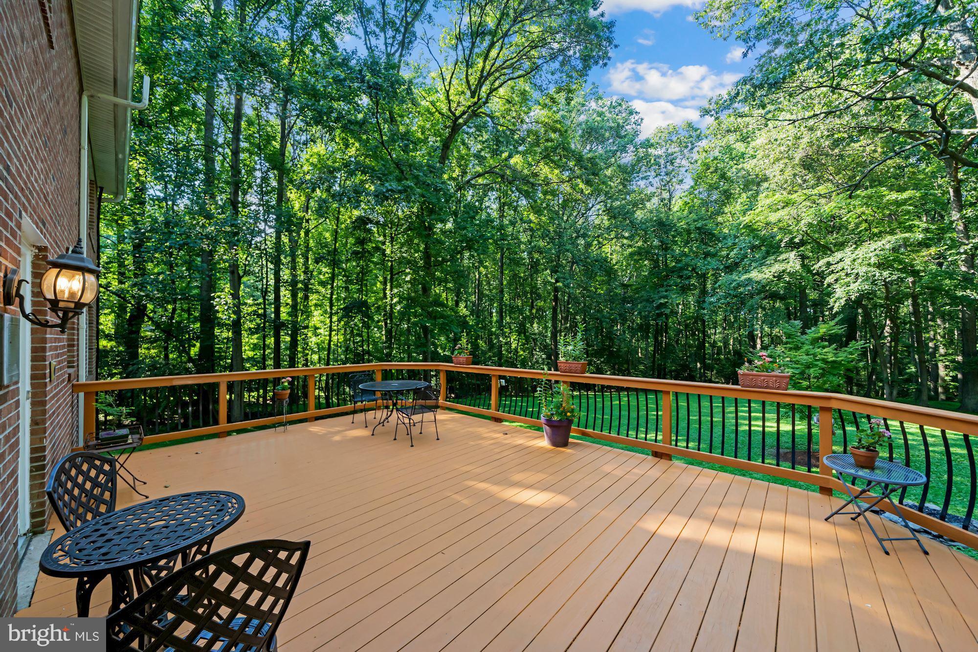 PRICE REDUCTION - Motivated Sellers!  Combining both privacy and convenience within the Langley School pyramid, situated on five, pastoral acres, and featuring two primary suites, you'll feel a world away! And yet you're close to the Great Falls Village stores and restaurants, nearby national and county parks, and a short drive to Tysons Corner, Reston Town Center and Dulles Airport. Once you arrive home to this quiet, idyllic setting, you may never want to leave! The welcoming outdoors is mirrored by the home's warm interior, where you'll find both primary suites along with two additional generously-sized bedrooms on the upper level. Working remotely is made easy with the main-level office featuring built-ins, and you'll enjoy both cooking and entertaining in the updated kitchen and the generously-sized family room featuring a wood-burning fireplace. Al fresco dining is just steps away on the deck which overlooks the flat, sweeping view of this incredibly private backyard. On the lower level you'll find a fully finished walk-out basement with a large recreation area and plenty of flexibility with two separate rooms for guests and/or an au pair, along with a full bathroom. Another bonus is an additional third, separate one-car garage which can double as an outdoor work space. Come see all this picturesque property has to offer...welcome home!