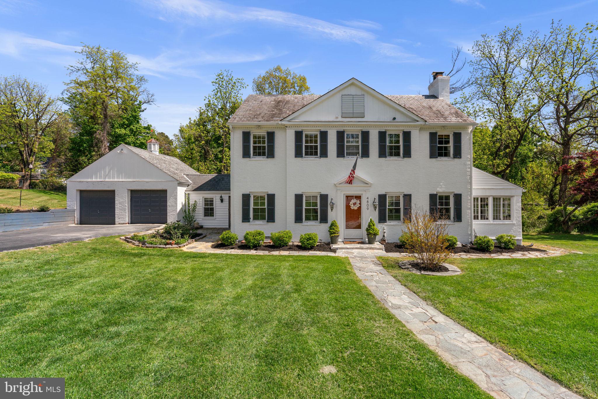 A true gem, this gorgeous Colonial has been completely renovated in 2023 and showcases a striking, fully whitewashed brick façade with waterproofing for added peace of mind. Ideally situated in the charming Ten Hills community, the home boasts exceptional curb appeal with rich, contrasting shutters, lush, professionally designed landscaping, and elegant stone pathways. Inside, the home offers a traditional layout infused with character, charm, and a uniquely inviting aesthetic. // A marble-floored foyer sets the tone, leading to a stylish powder room featuring glass block windows and polished brass fixtures. The formal living room features a cozy wood-burning fireplace, while a sun-drenched sunroom provides panoramic windows, continued stone floors, and a vintage painted glass ceiling fan, creating a bright and relaxing retreat. The family room offers versatility with dual exterior access, built-in cabinetry, and distinctive stone flooring. Hardwood floors flow throughout the formal dining room, highlighted by classic wainscoting, a sparkling chandelier, and built-in corner china cabinets that add timeless character. The thoughtfully designed kitchen showcases stainless steel appliances, quartz countertops, and a timeless black-and-white checkerboard floor, complemented by warm copper fixtures and a striking quartz backsplash. Off-white cabinetry with detailed paneling and custom oversized copper pulls adds a refined touch, while open shelving introduces both function and visual interest. // Upstairs, the home offers four bedrooms and two full bathrooms. Three bedrooms feature hardwood flooring, while one includes durable luxury vinyl plank. The primary suite includes a beautifully updated en-suite bath with an elegant tiled shower, brass fixtures, and a walk-in closet with custom built-ins. The uppermost level adds flexibility with a vaulted-ceiling bedroom featuring plush carpeting, along with a versatile loft space finished with LVT—ideal for a lounge, office, or creative retreat. // The fully finished walk-out lower level introduces a modern edge, featuring a spacious open recreation room with a sleek floating electric fireplace set against a wood-paneled accent wall. Exposed ceilings lend an industrial-chic feel, while a granite-topped bar with a beverage refrigerator creates the perfect setting for entertaining. This level also includes a second powder room and a bonus room with laundry facilities and additional storage. // Outdoors, enjoy a private patio and a beautifully landscaped backyard complete with a fire pit, all backed by mature trees for a serene and secluded setting.