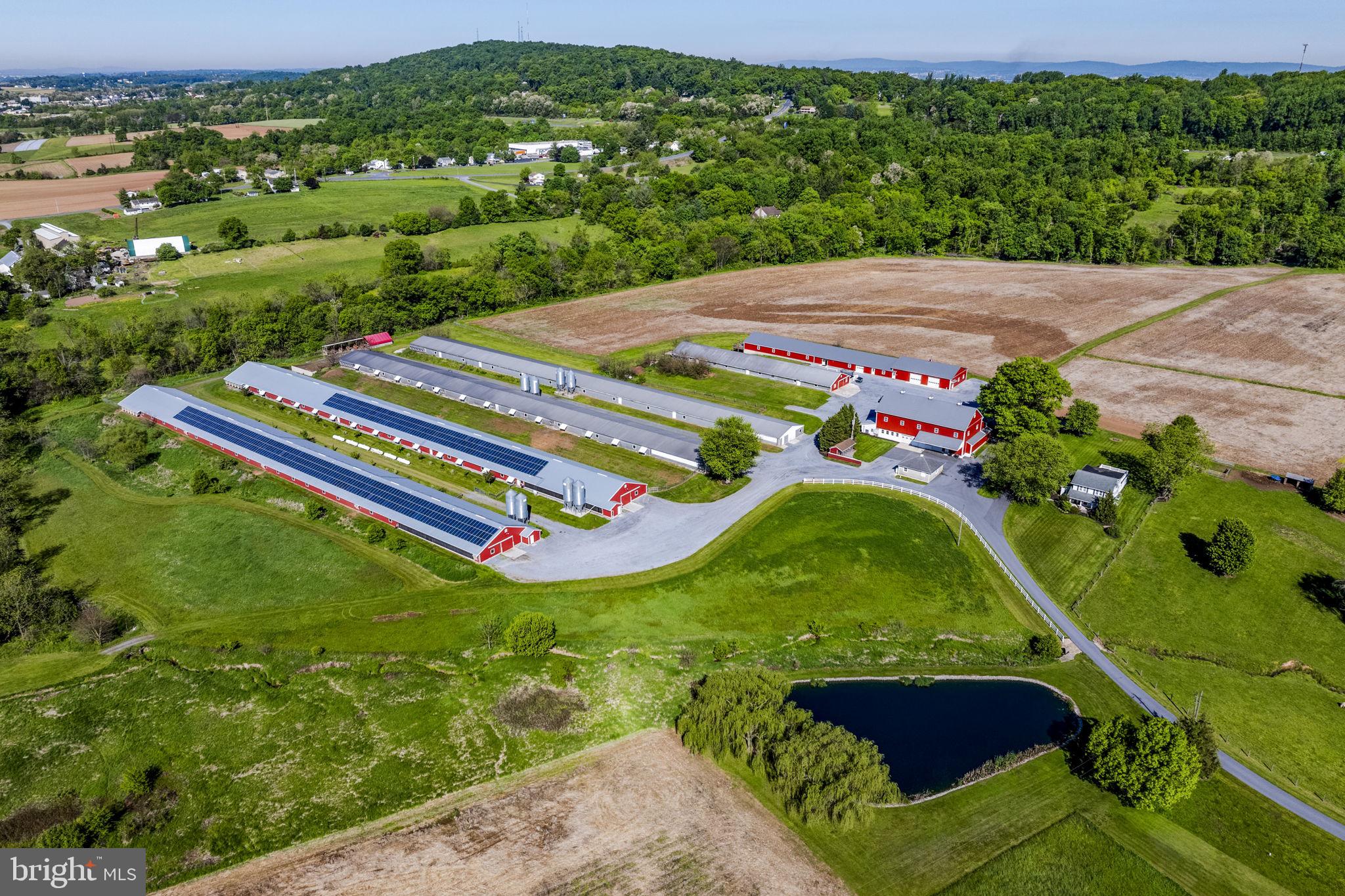AUCTION DATE - TUESDAY, AUGUST 11, 2026 AT 1 PM. LISTED PRICE IS AN OPENING BID ONLY AND IS NOT INDICATIVE OF THE FINAL SALE PRICE. REAL ESTATE: 66.4 ACRE Poultry Farm w/2 sty. frame/vinyl farmhouse w/2200 SF finished area, eat-in country kitchen w/Quality custom raised panel cabinets w/granite & Corian countertops, pantry & updated appliances including Jenn-Air glass top range w/down draft (only 1 yr. old), dining, living & family rms., office/den, 1st floor laundry/mudroom w/built-in cabinetry, 4 bdrms. (primary bdrm. suite w/bath & balcony access), 2½ baths, propane heat, central AC, bsmt. w/outside entrance, insulated/tilt windows, covered front & side porches, patio area & attached 2 car gar. Outbldgs: (4) poultry broiler houses w/(2) 550×54 up-to-date w/new cool cells & under contract w/Perdue/Coleman, (2) broiler houses 512×41 currently not in use (incentives from Perdue to put back into production), 5-bin roof composter w/32×24 hoop bldg., 2 sty. stone/frame bank barn 80×40 w/generator rm. w/150KW generator system, 1 sty. frame equip. bldg. 200×41, 1 sty. shop 80×44 (remodeled in 2023) w/attached 126×44 rec rm. (heated & insulated) & 1 sty. masonry shop/gar. 28×26. Special Note: 185KW solar system w/675 modules & 15 inverters (covers all farm electrical use w/income paid yearly). All on 66.4 ACRE income producing farm w/beautiful setting, approx. 33 acres tillable, approx. 7 acre fenced pasture, 5 acre wildlife habitat, 4 acre woodland, ½ acre stocked farm pond & Bowman stream run thru farm, on-site well & septic. Zoned Ag & enrolled in Clean & Green. Farm not preserved. NOTE: Owners have purchased other property & are motivated to sell! Tremendous opportunity to purchase 66.4 ACRE poultry farm in move in condition. Very well maintained. Must see property! Convenient location, minutes to Rts. 322, 222 & Turnpike. Terms 10% down, balance 60 days or before. Personal inspection by appointment or open house Sat., August 1 & 8 from 1 to 4 PM.