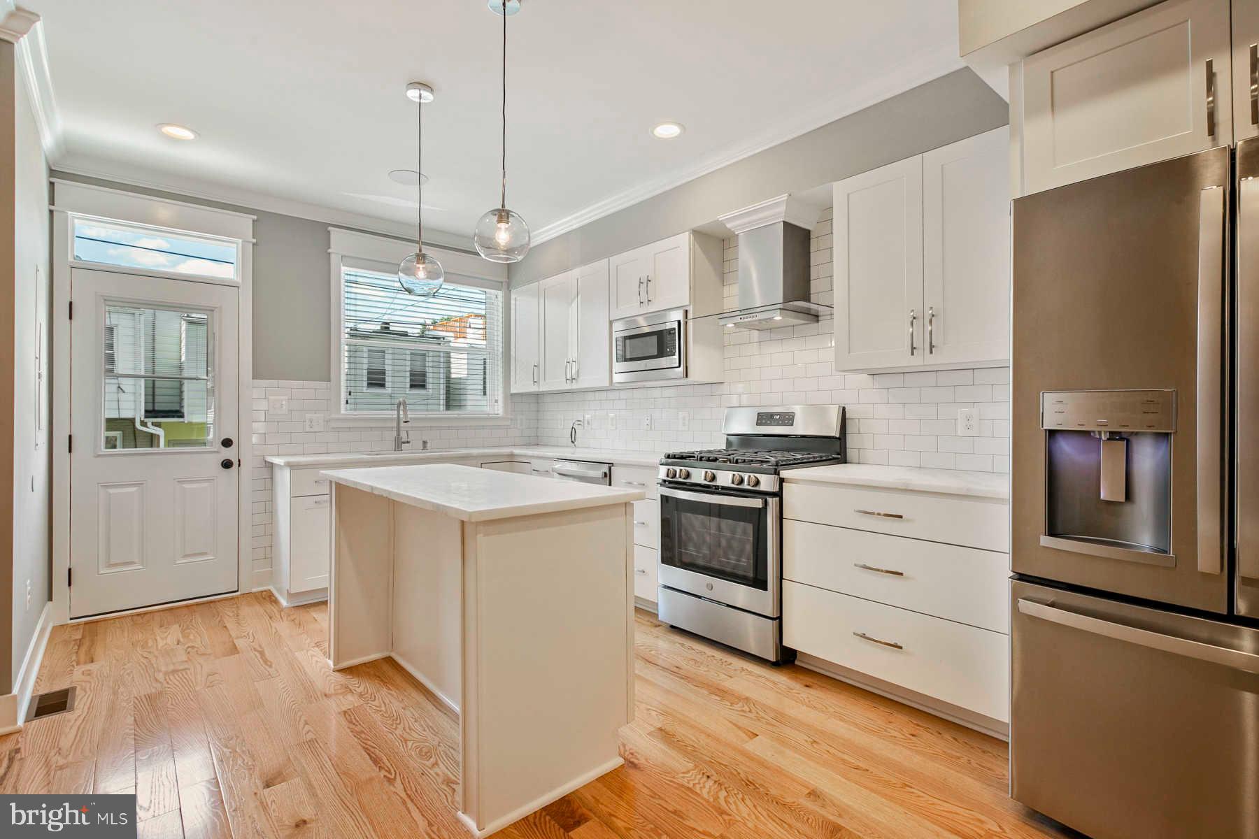 Approximately 8 years left on CHAP.  Beautifully renovated townhome with parking and rooftop deck, blocks from Canton Square. The main level is an open concept with kitchen and living room and gorgeous hardwood floors. The upper level has two bedrooms, two full bathroom and the lower level has two rooms, one full bathroom and laundry. Some highlights include custom tile, trim, stainless steel appliances, walk-in closets, and exposed brick.