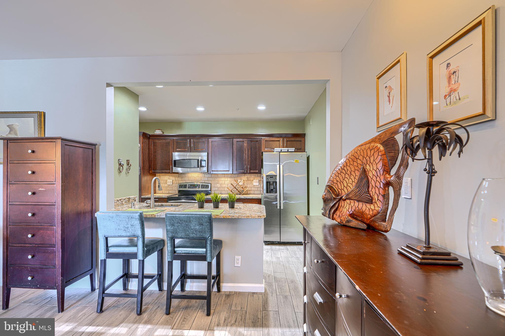 Rarely available two-story waterfront penthouse condominium in Henderson's Wharf, located in the heart of historic Fells Point. This spacious residence offers soaring vaulted ceilings, an open and light-filled layout, and spectacular harbor and city skyline views from an oversized private balcony.

The dramatic two-sided fireplace creates a warm focal point between the living spaces, while the unique two-level floor plan provides both comfort and privacy. The lower level features a spacious bedroom and 1.5 bathrooms. Upstairs, you'll find the kitchen, living and dining areas, fireplace, and direct access to the expansive balcony overlooking the waterfront.

This condominium includes a deeded garage parking space (#140 on the second level) with a private storage unit. Residents of Henderson's Wharf enjoy exceptional amenities, including 24-hour concierge service, a 24-hour fitness center, beautifully maintained common areas, and secure garage parking.

Perfectly positioned along Baltimore's waterfront, this home is just steps from Fells Point's award-winning restaurants, waterfront promenade, water taxi, Whole Foods, Harbor East, and downtown. Experience the best of waterfront city living in one of Baltimore's most desirable neighborhoods.