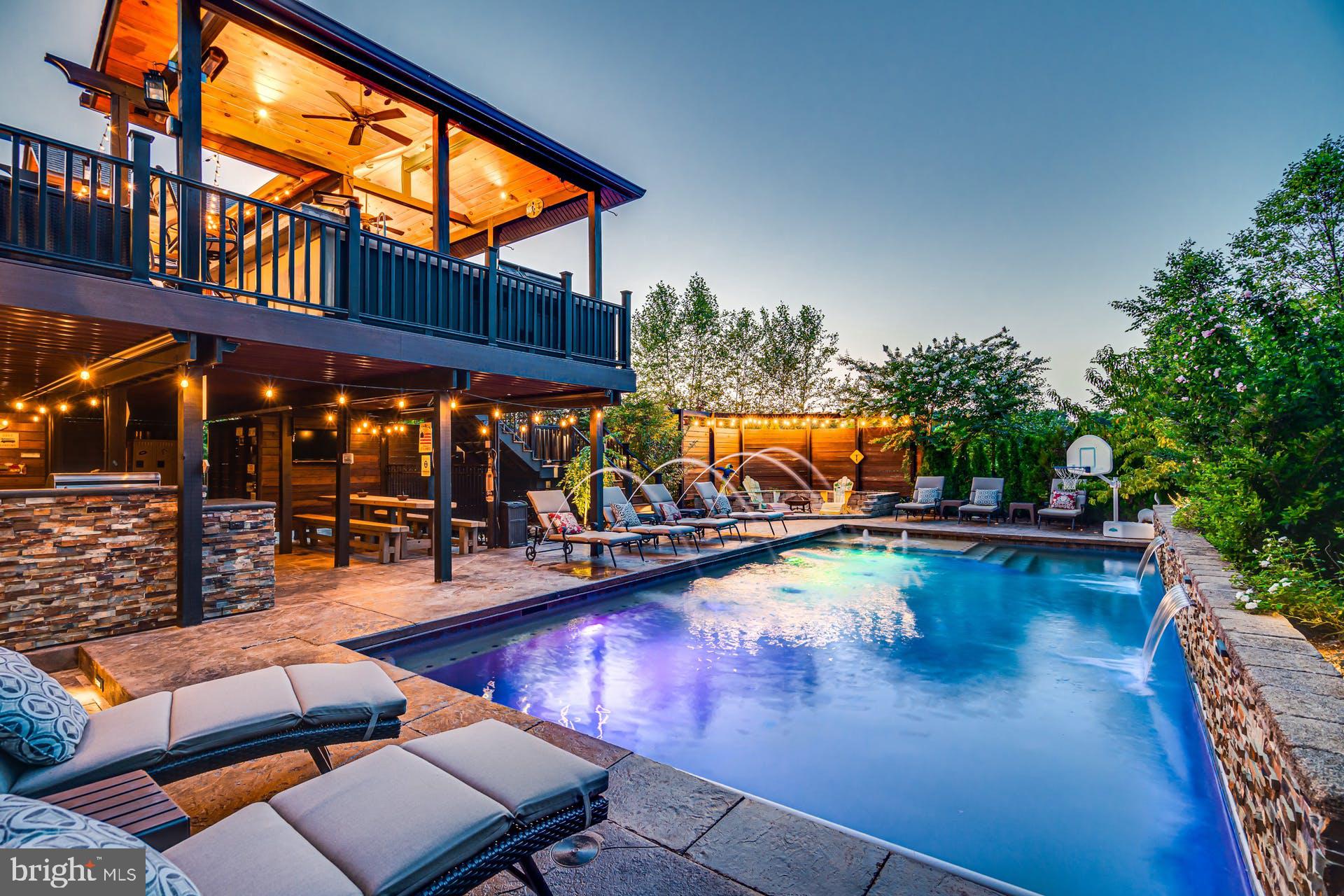 Open House Sunday, June 7th from 11am - 1pm! This amazing home in Martin's Chase is situated on a .37 acre lot backing to incredible parkland views and is a short walk to the new Reservoir Park.  Looking to entertain, this entertainer's dream home features an amazing outdoor oasis with a saltwater pool, a tanning ledge, cascading waterfalls, fountains and a retractable cover. Plenty of open and covered patio space, a great firepit and koi pond.  An oversized custom composite deck featuring a covered pavilion with heaters, ceiling fans and lighting.  To top it off, there is an amazing outdoor kitchen with an oversized grill, griddle, beverage refrigerator, sink, storage and bar seating.<br><br>The house has 5 bedrooms, 4.5 bathrooms, a 3-car side-load garage, 4,320 sqft on the main 2 levels and another 2,009 sqft on the lower level. The main level features a gourmet kitchen with granite countertops, abundant cabinetry, stainless steel appliances, a breakfast bar, and a breakfast room.  There is a wonderful family room with built-in cabinets & shelving and a gas fireplace. Off the family room is a private home office with French doors. Completing the main level are spacious formal living and dining rooms and a custom beverage center with wine storage, a beverage refrigerator, and a sink. <br><br>Upstairs you will find the luxurious primary suite, featuring a double-sided gas fireplace, tray ceiling, cozy sitting room and two walk-in closets, including one beautifully customized closet. The spa-inspired primary owner's bathroom features dual vanities and a huge walk-in shower with dual shower heads and body sprays. Completing the upper level are 3 additional bedrooms with walk-in closets, 2 full bathrooms and an oversized laundry room.<br><br>Continue the entertaining in your spacious rec room featuring a second kitchen/bar, built-ins and a fireplace.  Completing the walk-out level is your 5th legal bedroom, a full bathroom, a beverage nook, a sauna, a gym, and a tanning bed.Recent updates and features include both outside HVAC condensers replaced and lower level furnace replaced in 2022, sump pump and pool pump in 2025, over 6300 finished square feet, 10 foot ceilings on the main level and more!<br><br>Wonderful school zone with Independence High, Watson Mountain ( 6th & 7th grade ),Brambleton Middle ( 8th grade ) & Sycolin Elementary. Just a few miles from Brambleton Town Center, Fleetwood & Hartwood Wineries, Brambleton golf course, Metro Silver Line Loudoun Station and the new Reservoir Park with fishing, biking and kayaking! Don't miss the opportunity to make this amazing property your next home. Schedule a showing today!