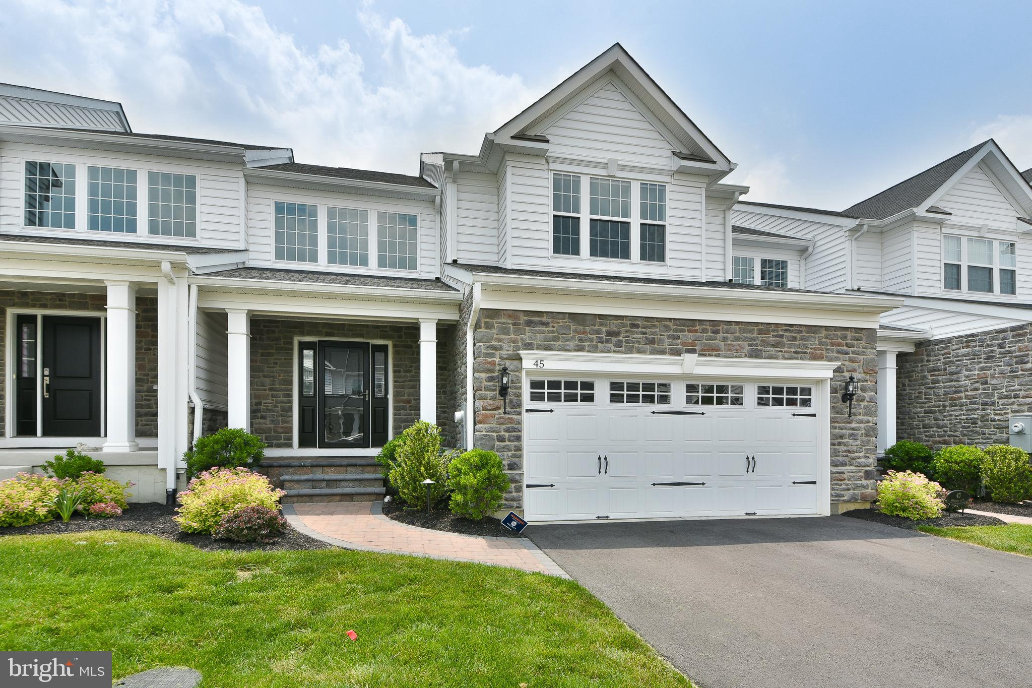 This stunning Carriage home in prestigious Regency at Yardley has over $100,000 in upgrades. The premium stone finish and path lighting will lead you to a charming portico.  Inside you will find an impressive two-story living and dining room with herringbone flooring and an open iron baluster staircase. The kitchen features upgraded cabinets, quartz countertops, a 6 burner Kitchen-Aide stainless steel gas range top with beautiful backsplash and upgraded luxury vinyl flooring. The family/Great room has a remote-controlled gas fireplace with thermostat and premium Hunter-Douglass window treatments. The back deck has maintenance free decking and a latch/lock gate that is perfect for keeping pets in, and foxes out. The primary bedroom suite is also on the first floor with two custom closets with shelving and drawers, one with a marble top and mirror.  The spa-like ensuite bathroom has heated flooring for those cold winter nights.  Upstairs you will find open bonus space that could serve many purposes.  There are also two generously sized bedrooms on this level. One comes with attached shelving and walk in closet. The other has a door to connect to the hall bathroom. The massive lower level of this home is fully finished with premium vinyl flooring and egress window. There is a storage area and plumbing has been roughed in for a future additional bathroom. There is a Pelican whole-house water filter, softener, and UV sanitizer. The garage is equipped with a Tesla wall charger. This active adult community has something for everyone. Indoor and Outdoor pools, tennis/pickleball, Bocce, fitness center, whirlpools, saunas, meeting rooms. All this and close to the quaint towns that Bucks County is known for. This home will check every box!
