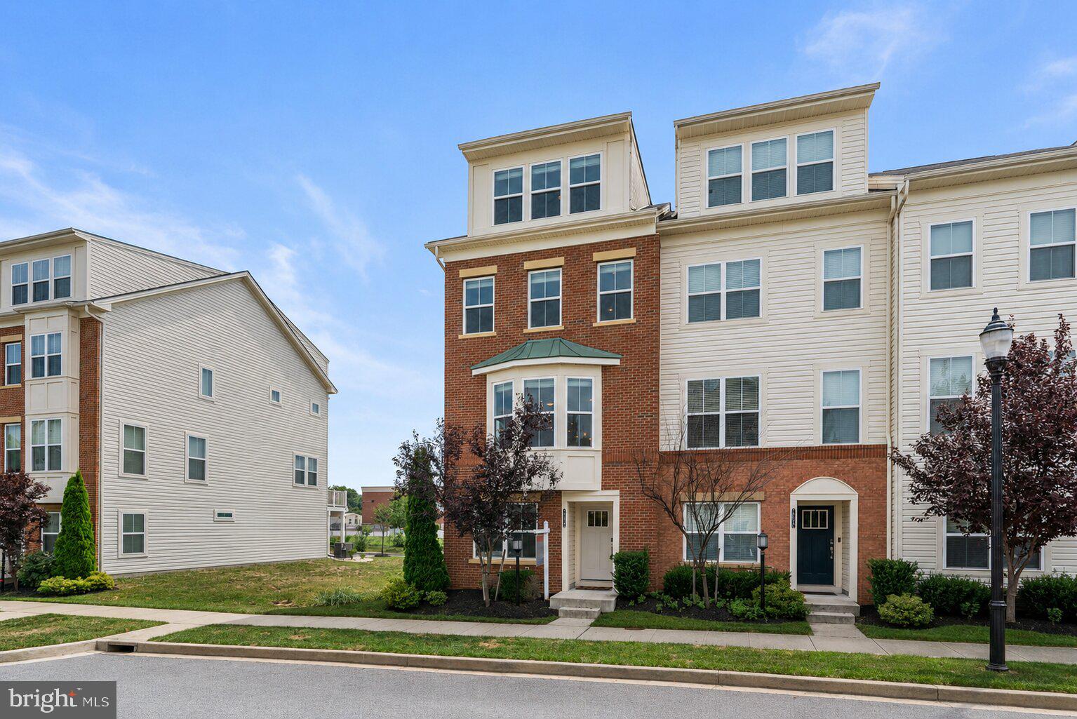 7024 Rackham Way | Move right into this beautifully appointed end-of-group, four-level townhouse offering the perfect blend of space, style, and flexibility in one of Howard County's most convenient communities. Just eight years young and professionally prepared for market, this exceptional residence features four true bedrooms, four full bathrooms, one half bath, multiple work-from-home options, and an abundance of natural light thanks to its premium end-unit location. Whether you're entertaining on the composite deck, enjoying your private fourth-level balcony, or relaxing in the expansive open-concept living spaces, this home offers the turnkey lifestyle today's buyers are searching for. Available for immediate delivery, just in time for the start of the school year. Property Highlights -- End-of-group townhome with nine additional windows providing exceptional natural light throughout -- Four finished levels with versatile floor plan -- 4 Bedrooms | 4 Full Bathrooms | 1 Half Bathroom -- Brick front elevation with professionally maintained landscaping and side yard -- Rear-load oversized one-car garage with additional storage bump-out -- Keyless entry system -- Video doorbell -- Hardwired Wi-Fi extension system throughout the home -- Fiber optic high-speed internet available -- Open-concept main level with seamless kitchen, dining, and living spaces -- High ceilings throughout every level -- Composite rear deck directly off the main level -- Fourth-level loft opening to a private balcony -- Multiple flexible spaces ideal for home offices, fitness, hobbies, or guest accommodations -- Brand new stainless steel appliances (2026 - Refrigerator, gas range, dishwasher, microwave) -- Granite countertops -- Oversized center island with seating -- Excellent cabinet and prep space -- Multiple en-suite bathrooms providing outstanding privacy -- Walk-in closets -- Spacious owner's suite -- Coat closet plus additional storage closets on the entry level -- Fresh interior paint (2026) -- New carpet (2026) -- Professional interior and exterior cleaning (2026) -- LEED Certified Silver -- Energy-efficient heating and cooling -- Composite deck -- Move-in ready condition -- Community swimming pool, fitness center, playground -- HOA includes Lawn maintenance, snow removal, trash service, community pool, fitness center -- Howard County public schools, sports fields, and playgrounds are within walking distance -- 3 miles to Timbers at Troy Golf Course, Howard County's premier public golf destination -- 4 miles to Arundel Mills, featuring shopping, dining, entertainment, and Maryland Live! Casino -- 8 miles to The Mall in Columbia, offering upscale shopping, restaurants, and entertainment -- Excellent Commuter Location; convenient access to MD-100, I-95, MD-295 -- This location also provides easy commuting to Columbia, Fort Meade, BWI Airport, Baltimore, Washington, D.C., and the surrounding employment corridors. There are virtually staged images in this listing.