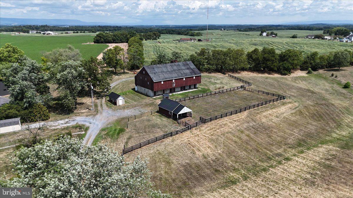 This 3.79 acre lot has so much to offer with endless potential!   Although there is no residence currently on the property, the lot is considered a building lot and suitable for one dwelling.  Public water and sewer hook ups are available through Peters Township.  The highlight of this property is a beautiful 40x80 historic bank barn with a gorgeous stone foundation and massive wooden beams that showcase the construction skills of the past.  The bottom level features many stalls and was recently scooped cleaned so the ground is nice and level. Equip with water and electric, the barn is ready for a new adventure!  Another featured building is the horse stable.  There are 2 stalls, a storage area, and an upper loft for hay.  The third building is a chicken house with a screened run area.  That building is currently being used for storage.  There is also a pump house which contains all the well equipment including a filtration system.  There is one large fenced pasture.  There are other portions that are partially fenced that could be finished with minimal effort.  One portion of the fencing is a solar array electric fence.  Part of the pasture area contains crushed stone underneath which was great for the horses.  There are 2 automatic water feeders that are  heated in the winter so animals have easy access to water all year long.    There is a stream on the property; however the previous owners wanted more pasture space so they installed a drainage tile and sod waterway allowing the creek to flow underground without disturbing the land above. Copies of these plans are available if desired.  All outbuildings have water and electric. If you are thinking about farming in the future, there may be grant money available through the Farm Vitality Planning Grant sponsored by the Pennsylvania Department of Agriculture.  Pictures won't do these buildings justice so come see for yourself all the potential this small farmette has to offer!
