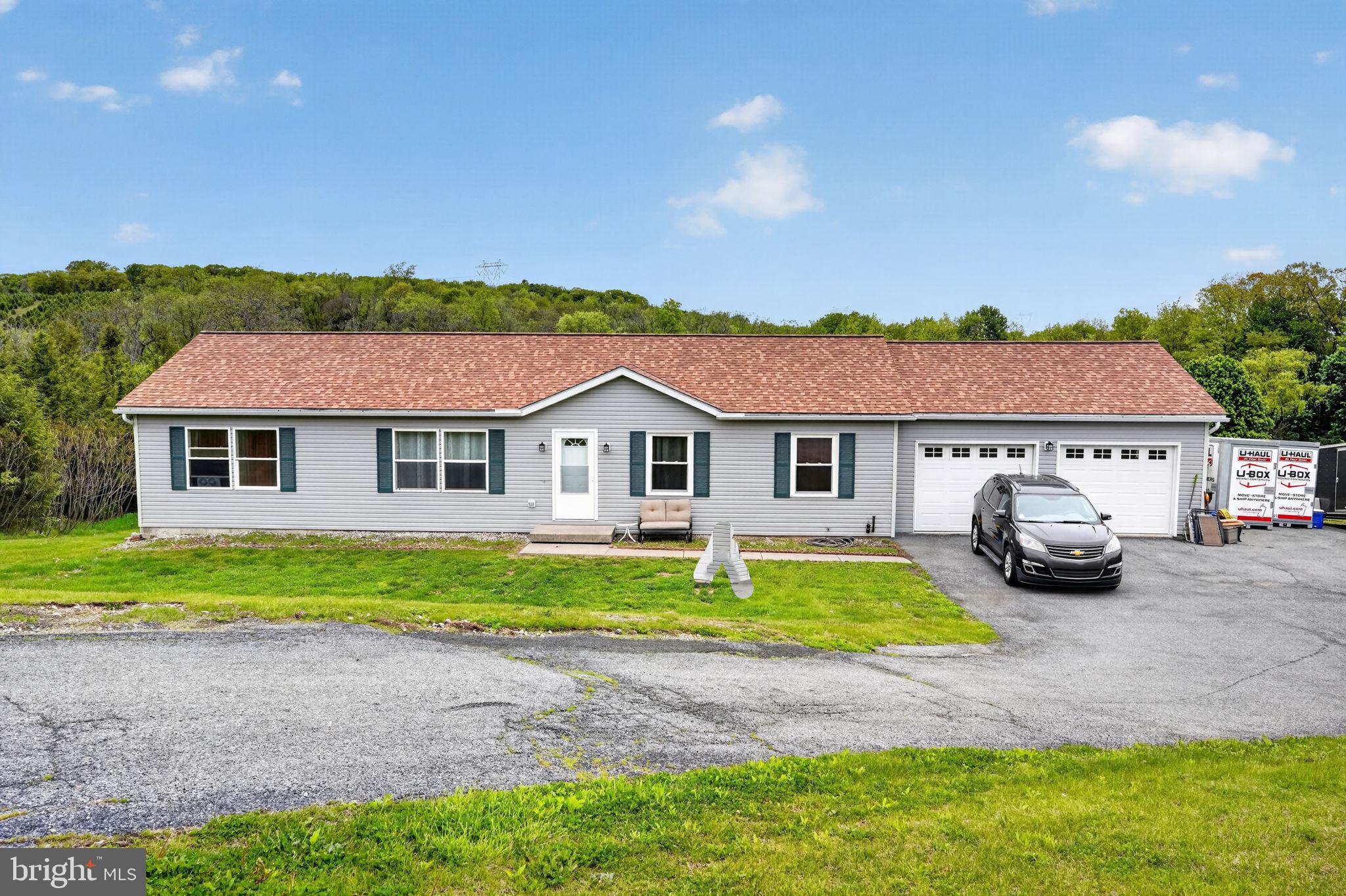 Move right into this 3/4 bedroom, 2 bath modular home situated on a scenic 1.4-acre lot. The spacious layout offers a welcoming living room, open kitchen and dining area, plus a dedicated office space. The primary bedroom suite is privately situated on one side of the home and features a full bath with a relaxing garden tub, while two additional bedrooms and a full bath are located on the opposite side for added privacy and functionality. The full walkout basement has been beautifully finished, adding a 4th bedroom, rec room, and utility room, with direct access to the backyard — perfect for additional living space, entertaining, or guests. Enjoy outdoor living with a backyard Trex deck and covered patio overlooking the scenic property. Recent updates include a new roof (2022), both garage doors and openers replaced (2021), new oil furnace (2020), new basement patio door (2025), new front door (2025), and new smoke alarms (2026). Plenty of room both inside and out, ready for its next owner to move right in!
