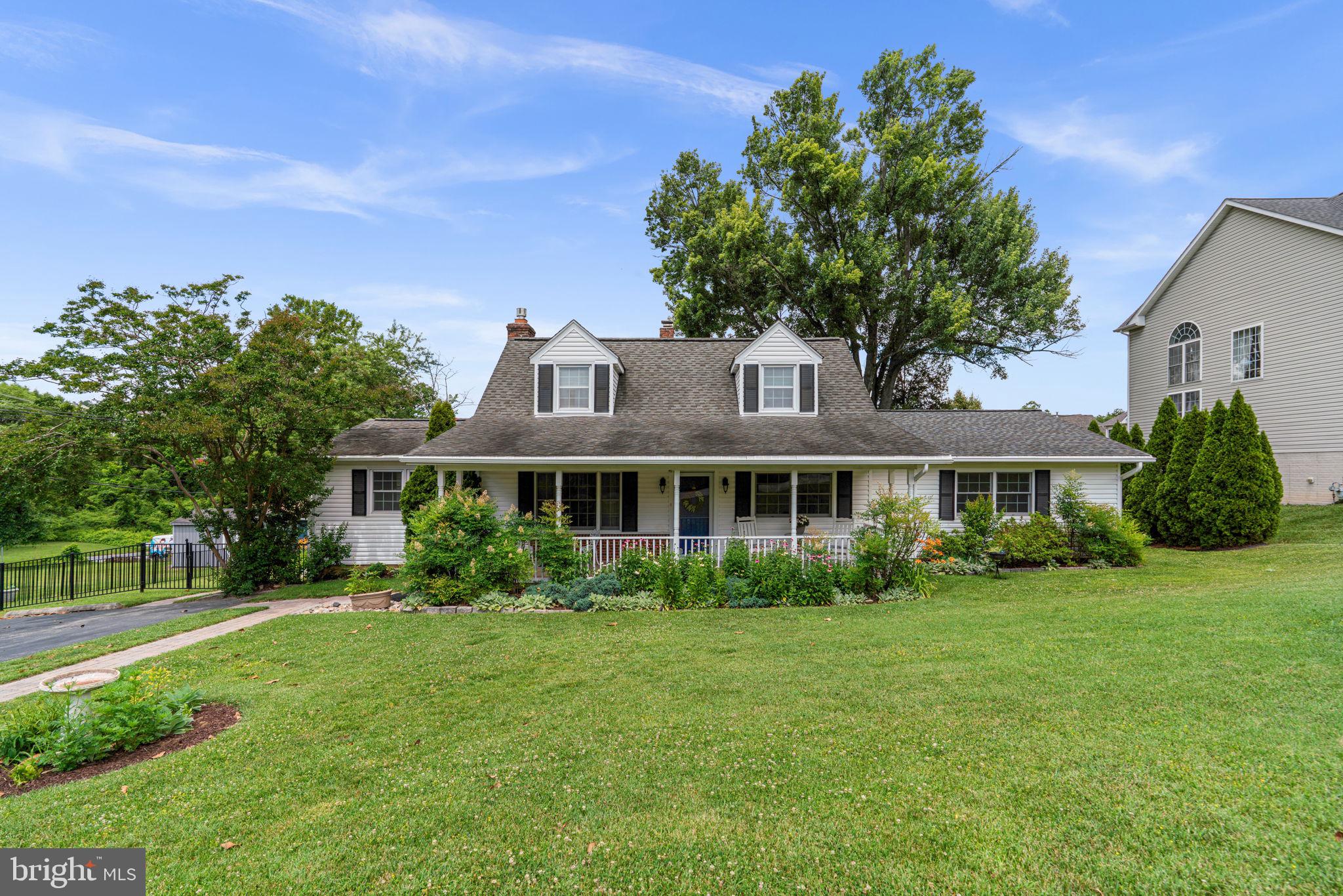 This home is a showstopper with an amazing floor plan featuring two large additions.  A covered front porch welcomes you into a living room with hardwood floors leading to a great room with slate flooring, brick walls, gas fireplace plus family and dining space leading to your gourmet kitchen with pantry, upgraded appliances and ample counter/cabinet space and the massive screened porch overlooking the yard.  There is a main level half bath and a stunning private primary suite with an enormous primary bedroom and sitting room, a full bath with dual vanities and make-up station plus an office or 2nd bedroom with built-in shelving, desk, closet and box bay window with bench.  The upper level has two generously sized bedrooms plus built-in drawers for storage, there is also a 2nd full bathroom.  The lower level is a family room with walk-out steps to the back yard, plus a utility room with laundry and a storage room/workshop with workbench.  Hardwoods on the main and upper level and LVP flooring on the lower level, ceiling fans, lighted closets, upgraded windows, whole house generator and so much more to mention!  The yard is an oasis and a quiet street as well.  You have to see this to experience the size, luxury and features.