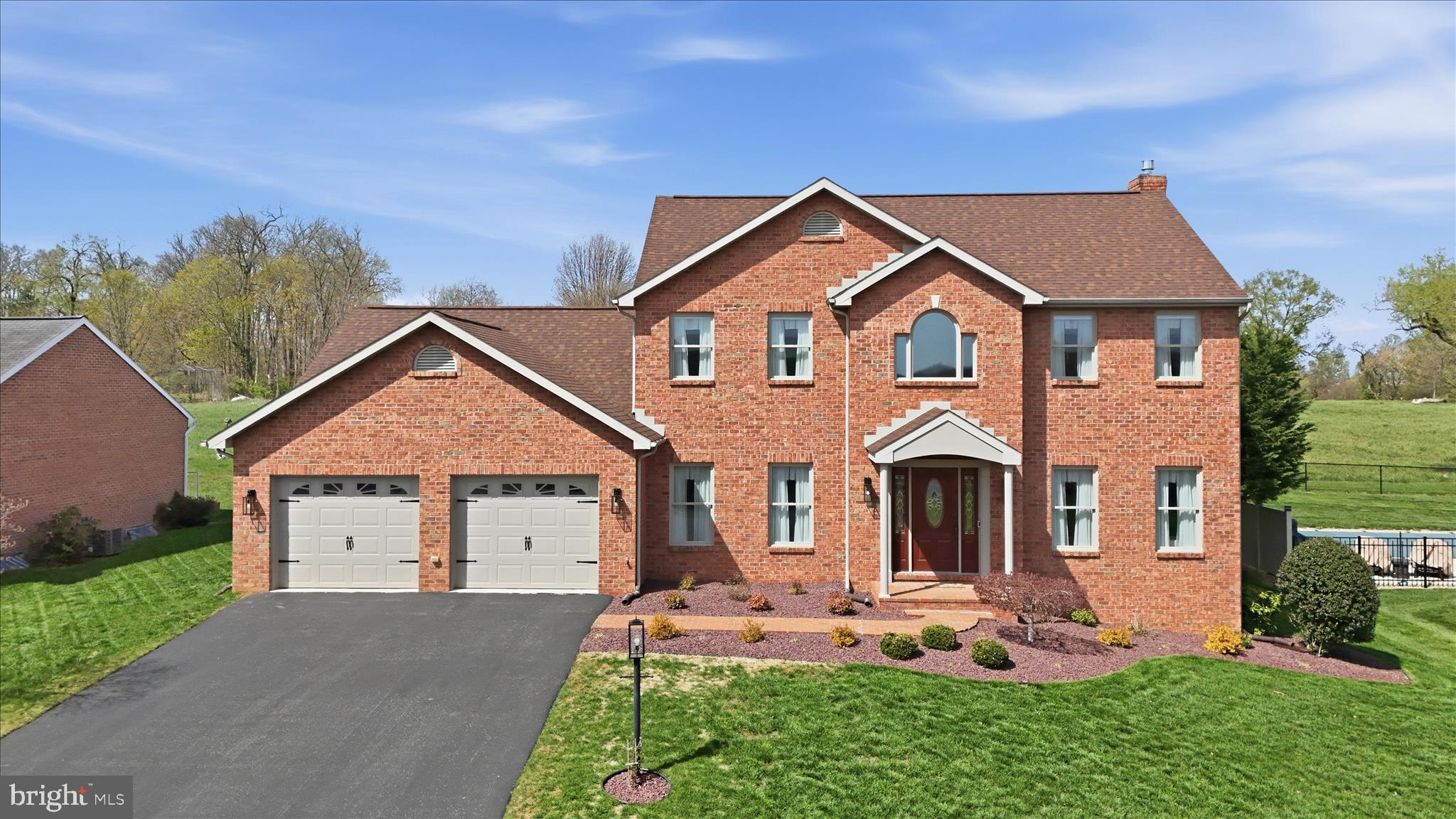 Welcome to 220 Montclair Ct, an elegant all-brick Colonial located in the Colonial Park East subdivision. Offering 3 bedrooms and 2.5 baths, this home combines timeless design with well-appointed finishes throughout. 
The main level features an impressive two-story foyer, a versatile office, and a formal dining room ideal for entertaining. The kitchen opens to the family room and is appointed with stainless steel appliances, granite countertops, a center island with seating, and a spacious dining area. The adjoining family room is anchored by an electric fireplace, creating a warm and inviting gathering space. A laundry room and half bath are conveniently located off the kitchen. 
Upstairs, all bedrooms are generously sized, including the primary suite featuring a walk-in closet and a private en suite bath with double sink vanity, soaking tub, and separate shower. 
The partially finished basement offers additional living space with a rec room, perfect for a variety of uses. 
Outdoor living is enhanced by a covered brick patio that extends to an open patio area, complete with solar patio lighting—ideal for both relaxing and entertaining. A water fountain is located just beyond the fenced yard.
Additional highlights include an attached 2-car garage and a newer roof (2021). No city taxes and no HOA. 
Conveniently located near shopping, dining, and commuter routes, and minutes from Meritus Hospital and Hagerstown Community College. 
Schedule your private tour today!
