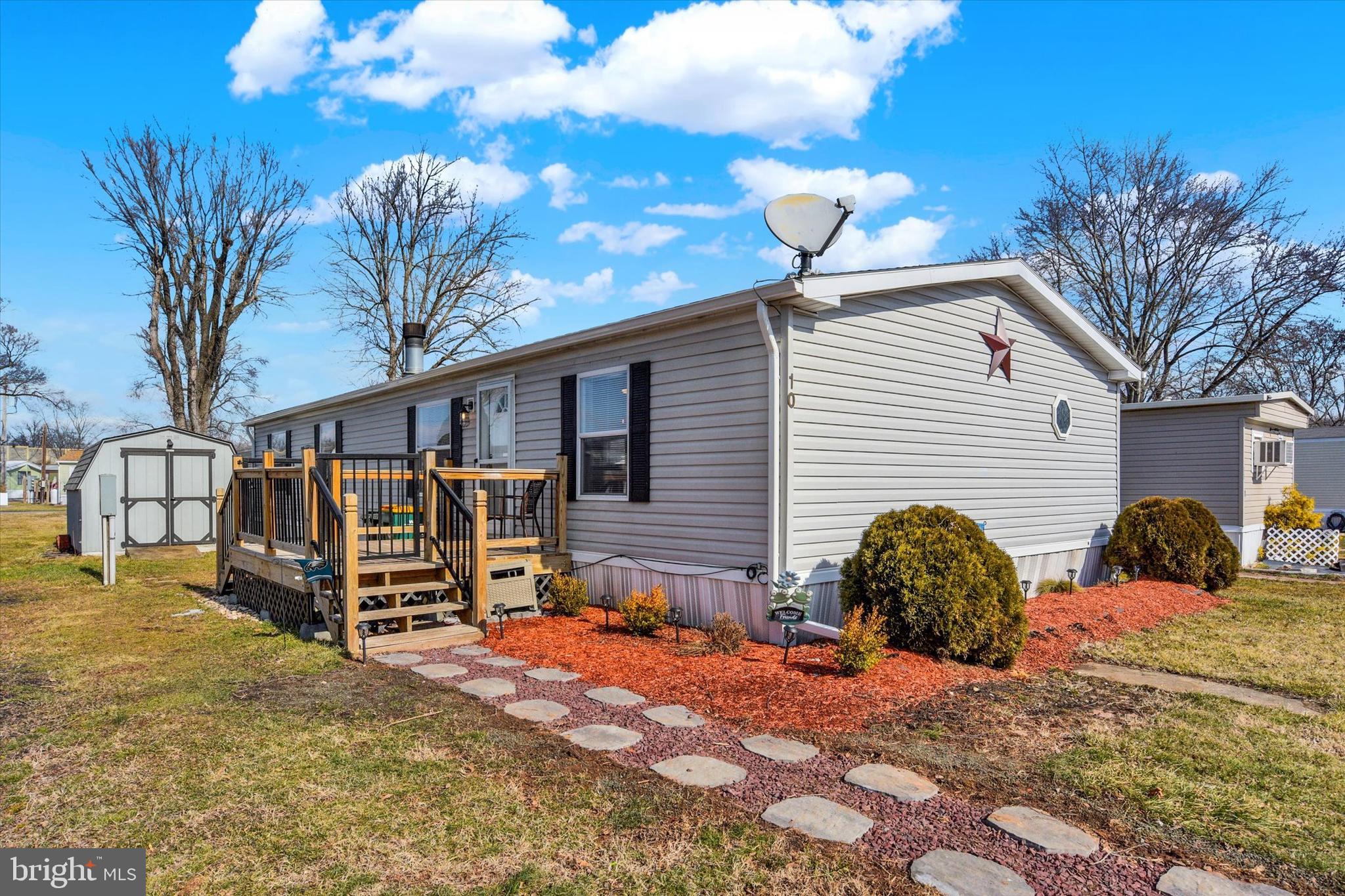 Welcome to 10 Vagabond Dr, Middletown in Harborton Estates. This double-wide manufactured home has been completely renovated. With new tilt-in double-hung vinyl windows, doors, luxury vinyl flooring, carpeting, baths, laundry, and kitchen. There is a new gated deck where you can sit and relax.
Newer roof, seamless gutters, and AC unit. The home has a real wood fireplace and a pellet stove for additional heat. Very affordable living. 12' x 12' shed. This home was originally a 3 bedroom, now a spacious 2 bedroom. A wall or door could easily be installed where the primary bedroom entrance is. Or a wall could be installed inside the main entrance door and the pellet stove removed for extra bedroom space. The possibilities are endless if you need to expand. (The side lot is vacant, the seller was told they can use it if they maintain the lawn). Buyer to confirm usage with the Park.