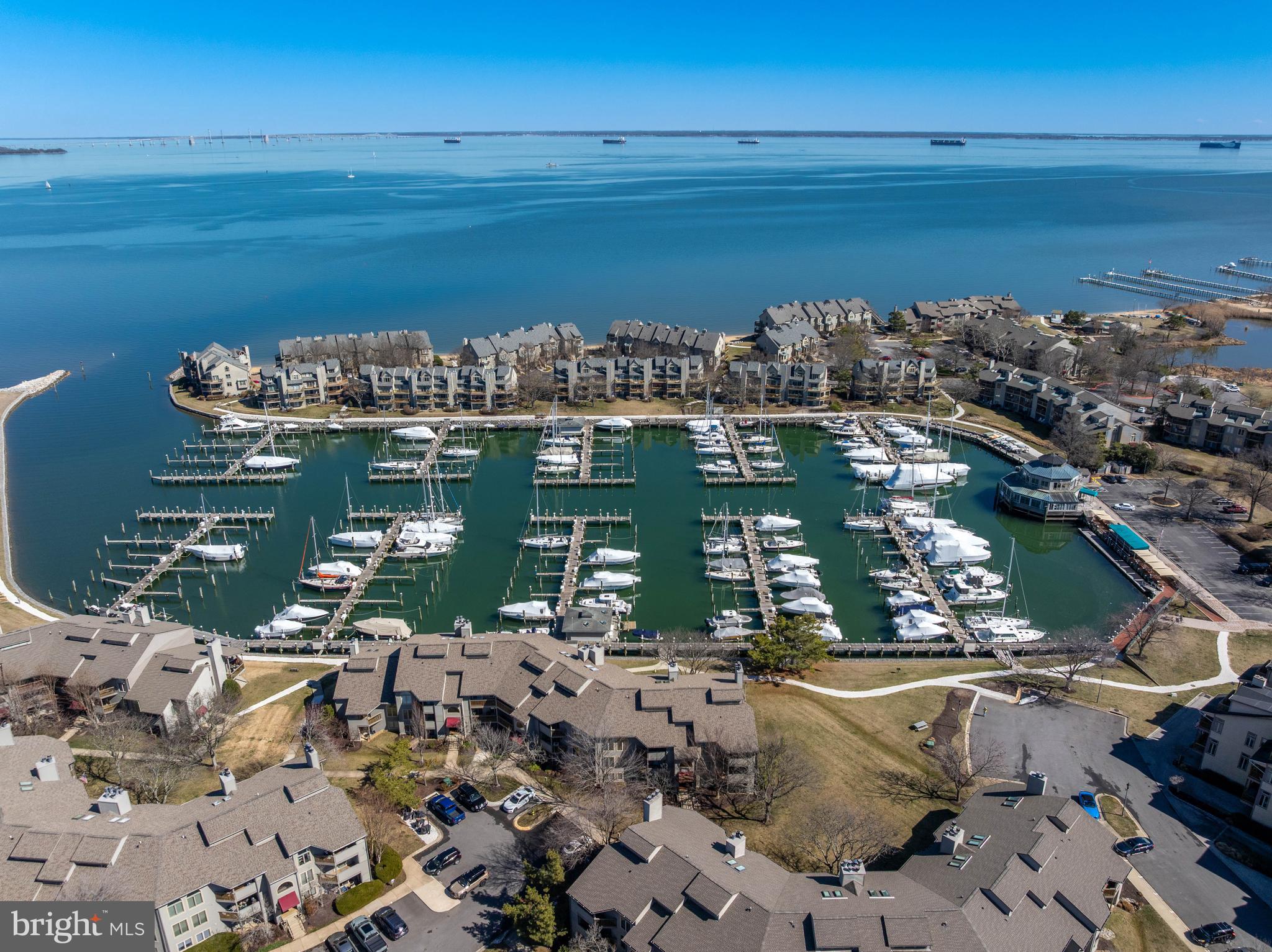 Overlooking the award-winning Chesapeake Harbour Marina and the Chesapeake Bay, this beautifully renovated residence offers sweeping water views within the gated waterfront community of Chesapeake Harbour. From the first light over the Bay to boats moving through the marina, the views create a constantly changing waterfront backdrop.

With more than 1,700 square feet of living space, this residence is one of the largest in the community and has been thoughtfully designed with sophisticated finishes and an open, light-filled floorplan that blends elegant interiors with the relaxed charm of Annapolis waterfront living. Located in a premier setting within the community, the Beacon Waterfront Galley and Bar is just a short walk away.

Outdoor living is a highlight of this residence. A large wraparound balcony extends from the living room to the primary bedroom, creating a wonderful space to relax while enjoying the views and activity of the marina. A private balcony off the kitchen offers the perfect spot for morning coffee or casual outdoor dining.

The loft level offers exceptional flexibility and easily functions as a home office or guest retreat. The space features a high-end Murphy bed with an integrated sofa along with remote-controlled blinds that provide privacy from the level below.

Over $200,000 in improvements have been made over the years, including a renovated kitchen, spa-inspired bathrooms, updated appliances, designer lighting, solid wood interior doors, custom Pella windows, A NEWLY INSTALLED HVAC SYSTEM (2026), wood flooring in the kitchen and entry, high-end floor coverings, and replaced fireplace surround, doors, and chimney.

Residents of Chesapeake Harbour enjoy resort-style amenities including 24-hour gated security, two swimming pools—one a Bayfront pool located directly on the beach—private sandy beaches, a fishing pier, tennis and pickleball courts, scenic walking paths, kayak launch, an EV charging station, and a deep-water marina with full yacht services. 

Come experience this private waterfront community where marina views, sandy beaches, and an active Chesapeake Bay lifestyle are all part of everyday life.