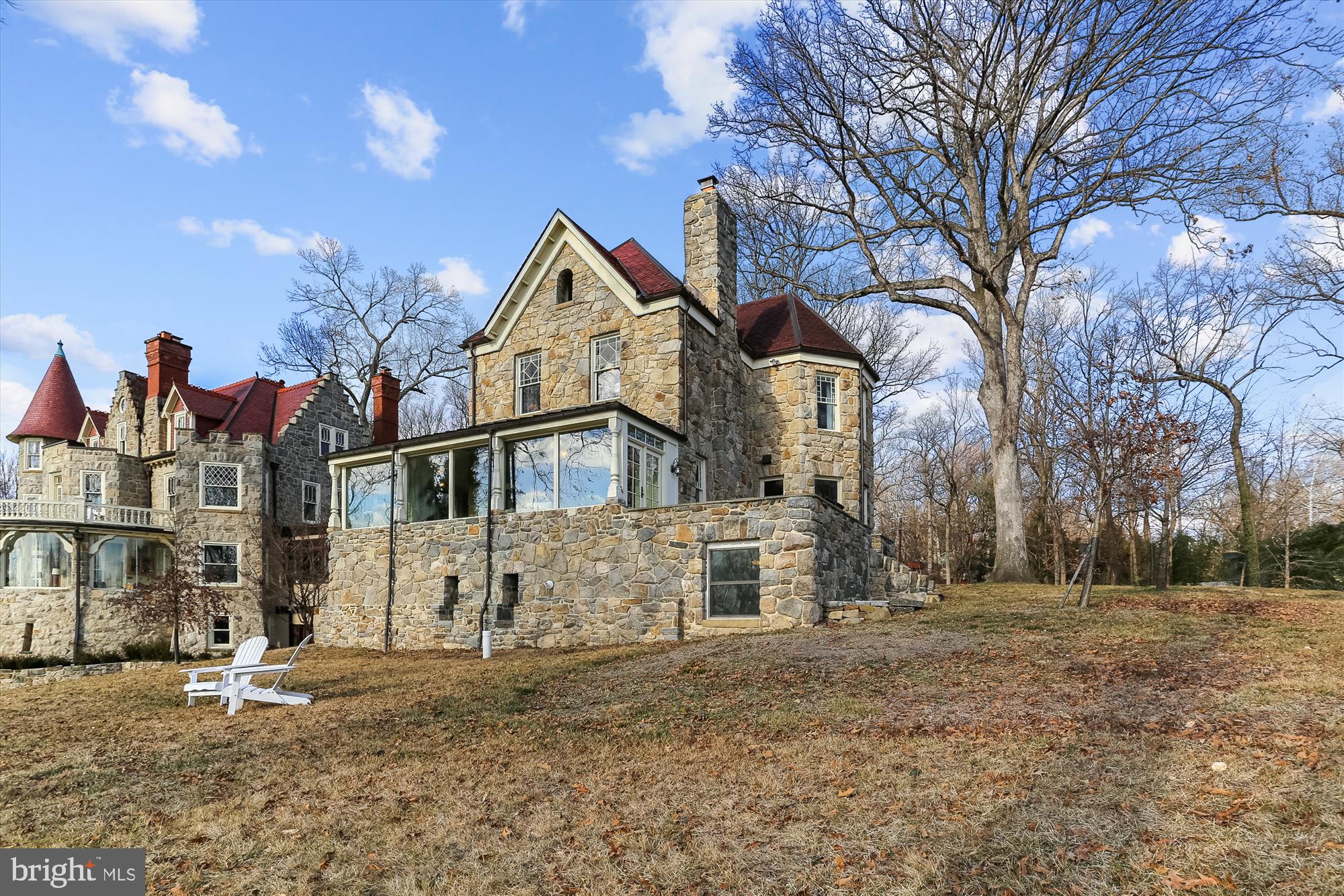 With panoramic views of the Potomac River and over 4,000 square feet of living space, this stately 5 bedroom, 4 and 1/2 bath, solid-stone home is known throughout Bethesda as the “R.A. Charles Castle.” The "castle" features a large open-plan main floor flooded with natural light. There is French door access to a large stone terrace for outdoor dining. Also on the main level is a 1/2 bath, large walk-in pantry,   kitchen bar seating and a beautiful wood burning fireplace. On the main floor you will appreciate the multiple seating areas and the large dining room with butler's bar. Don't miss the breakfast area on the enclosed former porch which is a perfect spot for morning coffee as the sun rises over the river. On the second floor are three bedrooms and two full baths including a primary bedroom with en suite that features a large walk-in steam shower, separate tub and notable solid marble double sink. The third floor consists of a large bedroom/loft, also with en suite bath. The lower level is currently a capacious family room with additional storage, wine cellar, 5th bedroom and full bath. There is a fully roughed in kitchen on this level if any future plans include an in-law or au pair suite. Only the highest quality materials were used throughout the home including solid Mahogany interior doors throughout.

The provenance of the “R.A. Charles Castle” can be traced back to 19th century industrialists Edward and Edwin Baltzley. Born into an Ohio family of industrialists and inventors, the twin brothers dreamed of developing a “Rhineland on the Potomac.” To finance their bold endeavor, Edwin used the fortune he’d amassed from his invention of the spatter-less eggbeater, to purchase 500 acres of land on the bluffs above the river on Conduit Road (today known as MacArthur Boulevard). 

The Baltzley brothers envisioned a community for the wealthy and upper class that would be the hub of culture and education in suburban Washington. They helped establish the National Chautauqua of Glen Echo, part of a movement that offered education and entertainment to the middle class, and founded the companies that built trolley lines to Glen Echo from Chevy Chase and downtown Washington, D.C.

In February 1890, R. A. Charles, an employee of the Treasury Department, purchased land from Edward Baltzley and began construction of his home. Theophilus Parsons Chandler, who designed the "Baltzley Castle" next door, is believed to have been the architect for both properties. Hired for the cache of his name, Chandler was best known for designing palatial country homes, ornate churches and grand enclosures at the Philadelphia Zoo.

In addition to being placed in the Maryland Inventory of Historic Properties, the “R.A. Charles Castle” was fully renovated in 2013. The home boasts a picturesque view of the Potomac River and tastefully combines the design elements of stone, brick, steel, glass and wood. It is easily one of the most distinctive properties in Bethesda. With its documented province and stately design, this offering presents a rare and wonderful opportunity to own a piece of Bethesda history.