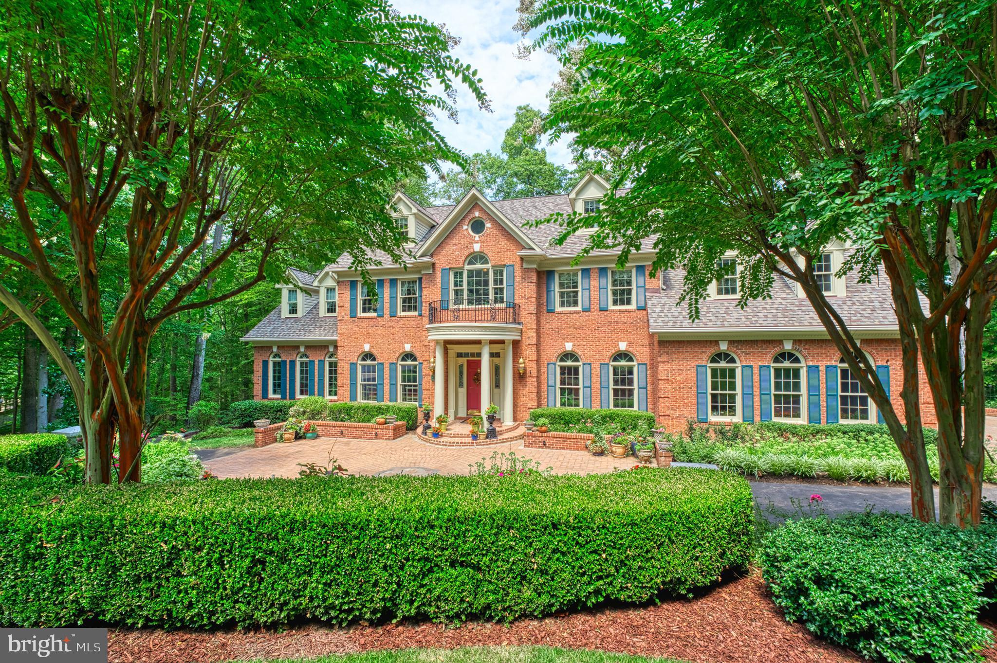 Seller has an Agreement of Sale with contingencies.  Property is available to show and accept backup offers**Welcome to 8700 Rustic Oak Ct, a magnificent custom-built brick home sitting on just over 5 acres in the serene and wooded landscape of Fairfax Station. With 5 bedrooms and 5.5 bathrooms spread over four levels, this home is the epitome of elegance and comfort. As you approach the property, you'll be greeted by a circular driveway anchored with brick columns and beautiful landscaping. The yard features extensive hardscape with multiple patio areas, two decks, stone walls, a stream with pond and landscaping lighting throughout creating a peaceful retreat. Step inside the grand two-story foyer, adorned with marble flooring featuring a custom mosaic inlay, a stunning crystal chandelier and beautiful circular wood staircase. Hardwood floors flow throughout the main, upper 1 and lower levels adding to the elegance of the home. Custom trim work, including crown moldings, chair railings, arched entry ways, and ceiling medallions as well as French doors, beautiful upgraded light fixtures, and custom window treatments are found throughout the home. The main level features formal living and dining rooms, library with custom built-ins, solarium, family room, Chef's kitchen and a half bathroom. There's also a separate four seasons room perfect for enjoying the scenic views. The kitchen boasts 42" custom cabinetry with solid brass fixtures, granite countertops and flooring, center island and breakfast room. Adjacent to the kitchen is the family room, complete with a brick fireplace and built ins. Step out onto the large deck from the breakfast room, family room or four seasons room. Oversized sideload garage has a Blue Viking custom storage system with epoxy flooring. Head up to the first upper level, where you'll find the primary bedroom with adjoining sitting room featuring a sky light and wood-burning fireplace. The primary bathroom offers marble flooring, double vanities with marble countertops, a jacuzzi tub with jets, separate shower, and water closet. Three additional bedrooms and two full bathrooms complete this level, along with a convenient laundry room. The bonus fourth level serves as a great guest suite, featuring a bedroom with a large walk-in closet and an additional closet with shelving as well as a full bathroom and storage area. The finished walk-out lower level is designed for entertainment, with a large recreation room featuring a wood-burning fireplace custom wet bar and surround sound. This level also includes an exercise/media room, along with a full bathroom and an all-purpose/game room/second office with built-in custom cabinetry. Multiple storage options can also be found, including a workshop room, utility room, two storage areas under the stairs as well as ample closet space. From the lower level, two doors lead to patio areas, perfect for outdoor gatherings and relaxation. The location of this property is highly desirable, with easy access to Route 123, Fairfax County Parkway, and Route 95. Enjoy the convenience of nearby shopping, downtown Occoquan, and the beautiful Fountainhead, Occoquan and Burke Lake Parks. Some of the more recent updates: Roof 2019, resurfaced asphalt driveway 2021, replaced septic tank pump 2024, vinyl siding 2020, reconfigured front courtyard 2020, replaced main level heat pump and handler and upper- level heat pump 2015, exterior lighting upgrades 2022-2023, replaced lattice under deck 2020. Extensive hardscape updates to the property alone exceed $150,000 and do not include landscaping, decks and exterior lighting costs. Other improvements made by the Owners include kitchen, bathrooms, flooring, finishing additional rooms in the lower level, replacing all light fixtures and more! Don't miss this opportunity to own a truly remarkable home in Fairfax Station. Schedule your private showing and make this dream home your reality!