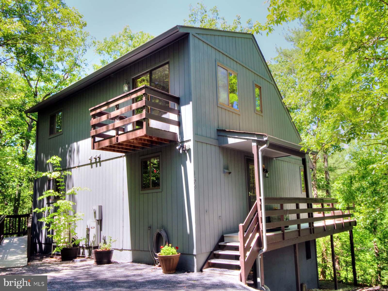 159 Richmon Rd - Put on your bathing suits and pack your picnic lunch, 'cause you're only about 200 feet from Lake Laura Beach.  Quite the location!  What a savings--walk rather than drive to the lake.
When constructed in 1990, the exterior walls were framed from 2x6 material for added insulation.  The
T-111 siding was recently sealed with a coat of stain.  The kitchen was recently refurbished with modern appliances,  granite countertops, and a ceramic tile backsplash.
All interior walls are sheathed with either wood paneling or tile-like paneling in the baths.  Absolutely no painting inside.
The entire house is enhanced with a Generac generator.   No more worries during those dreaded outages.
The master bedroom and private bath are on the main floor, along with a powder room with the washer and dryer, and the great room featuring a wood-burning fireplace and two skylights.  The upper level has two bedrooms and a bathroom in between.  Both bedrooms have separate balconies.
The fourth bedroom is located on the lower level.  The rec room has a reliable wood stove.  Ceramic tile covers the basement floor.  This is a delightful home you really shouldn't miss.