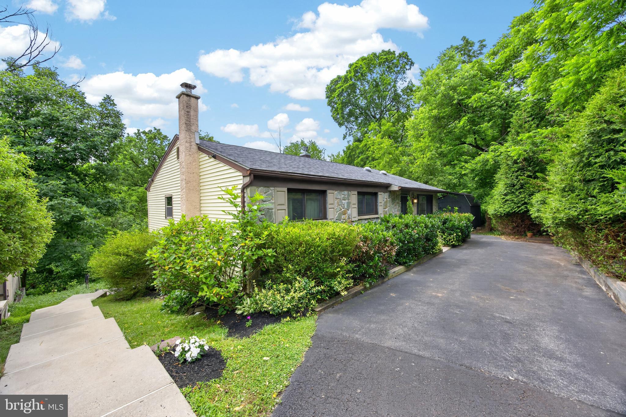Cool Vibes, Nature Views & Exceptional Privacy
Tucked away on a quiet cul-de-sac and bordered on two sides by preserved land within Evansburg State Park, 752 Raynham Road offers a rare blend of privacy, character, and natural beauty. This inviting raised ranch home creates a peaceful retreat while remaining conveniently close to everyday amenities.
As you arrive, mature landscaping sets the tone and creates a secluded setting, while exterior steps lead to the lower portion of the backyard and outdoor living spaces. Step inside and immediately appreciate the warmth of hardwood flooring, crown molding, and thoughtfully curated design details throughout.
The open-concept main living area creates effortless flow from room to room. The living room welcomes you with a large picture window that fills the space with natural light, enhanced further with more natural light provided by the solar tube skylights. A gas stove adds warmth and ambience, creating a cozy gathering space. The adjoining kitchen is both functional and beautifully designed, featuring extra-high hickory cabinetry, granite countertops, tile flooring and backsplash, pantry storage, deep single-bowl sink, dual-fuel double oven range, exterior-vented range hood, dishwasher, garbage disposal, refrigerator/freezer, built-in shelving, stained glass accents, and two ceiling fans. Just beyond, the dining area opens through double glass doors onto the expansive deck—an ideal place to enjoy peaceful wooded views of Evansburg Park and the Skippack Creek with morning coffee, sunset dinners, and stargazing under the night sky. The primary suite offers a serene retreat with three windows overlooking the backyard, a cedar closet, and custom Craftsman solid pine doors, door to bath has a glass door knob from an historic hotel in NY. The ensuite bath is finished with marble flooring, tub with subway tile surround, wainscoting, built-in shelves and cabinet, crown molding, heated toilet seat and a tub/shower combination. Two additional bedrooms complete the main level, each featuring hardwood flooring, decorative Craftsman solid pine doors, generous closet space, and easy access to the hall bathroom complete with a walk-in shower with glass door, granite vanity, ceramic flooring with an artistic flair, and crown molding. Through an ornate decorative glass and solid pine door, the staircase leads to the finished lower level designed for comfortable everyday living. This spacious family room features hardwood look flooring, recessed lighting, a wood-burning stove with stainless steel-lined chimney and striking Pennsylvania rock surround, abundant natural light, and double glass doors opening to the rear patio.
The lower level also includes a distinctive half bath featuring an antique cast-iron sink with antique silver-plated fixtures, along with a laundry area with utility sink and additional flexible space ideal for storage, a workshop, home gym, or hobby area. Completing the property are a detached shed and oversized workshop—perfect for tools, equipment, projects, or small machinery storage. A chicken coop for fresh eggs all year long! Generator included.  Located within the highly sought-after Methacton School District and just minutes from shopping, dining, and entertainment at Providence Town Center, this hidden gem delivers a unique opportunity to enjoy nature, privacy, and convenience all in one exceptional property.