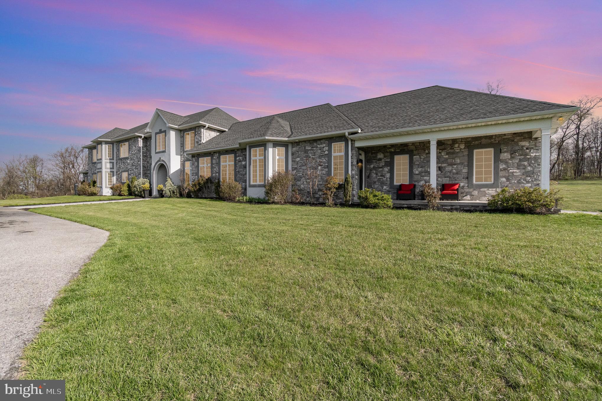 Drive up the winding driveway and as the anticipation builds this Masterpiece home comes into view.  This 6,000 square foot home is made for multi-generational/family living and sits on 26.68 acres situated on top of a hill giving you breathtaking panoramic views.   This home has 2 wings with a shared center hall starting with the main entrance featuring a 2 story majestic foyer with open staircase.  Continue straight to the Formal dining room/Media room with wall linear gas fireplace.  This room leads to the covered rear porch.  Let's start with the main house which is to the left of the foyer.  The open floor plan grants you clear visibility from the living room to the stunning custom kitchen offering granite countertops, pot filler, island, breakfast nook, walk in pantry and stainless steel appliances.  The 1st floor owners suite has 2 walk in closets,  and the ensuite has a tile shower, double vanity and jacuzzi tub.  The laundry room finishes up this 1st floor.  Upstairs there are 4 big bedrooms, 2 full baths, each Jack and Jill style, and one has double sinks.  There is also a bonus room that can be used as an office, hobby room, guest room, whatever you want it to be.  This side has an attached 3 car garage as well!  Now, let's go over to the other side of the home.....this side offers an open floor plan as well with a family room with coffered ceilings and corner gas fireplace that is open to the stunning kitchen with island, staggered cabinets, wall oven, pot filler, granite countertops, stainless steel appliances and breakfast nook.  There is a nice size bedroom with trey ceiling and a dream ensuite with walk in closet, custom tile walk-in shower with dual shower heads, and double vanities.  The office has a built-in desk with cabinets, drawers and bookcases.  Another laundry room, a half bath, and a 2 car attached garage finish up this side.  The back yard let's you have a vacation every day of the summer with the covered patio, a hot tub and heated pool (propane is not connected yet), there is a big play area and lots of area to have a firepit, or just run around in.  This home would also be perfect for an air B & B to bring in extra income too!!   This home is enrolled in Clean & Green giving you a break on your property taxes.  This home is truly spectacular and the home you've been dreaming of!

 Note the interior pictures are of the shared space and the second family wing NOT primary side.