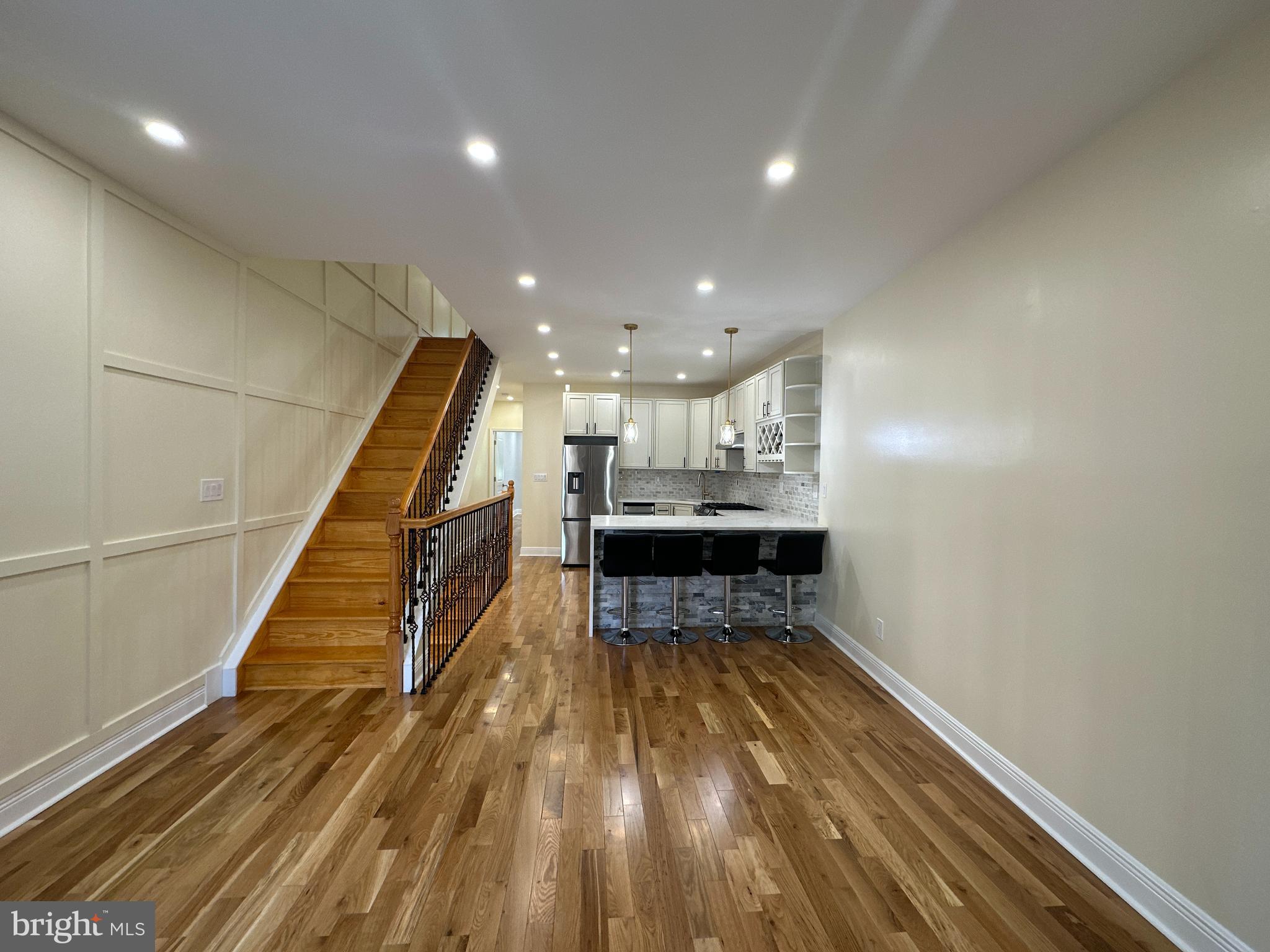 Remarkable 4 bedroom 2.5 bath home semi-detached home in Philadelphia! Great curb appeal featuring new stucco, pavement, handrail, windows, and 200 amp main line. Enter to a fully open concept plan main level with all new hardwood (Heater) flooring and recessed lights. The kitchen allows for plenty of guest seating with large peninsula-shaped base cabinetry equipped with waterfall quartz countertop and overhang. Nice custom backsplash, great upper cabinets including wine rack, pendant lights, and all new stainless steel appliances. Main level offers a nice size bedroom and full bathroom with floor-to-ceiling tile and a large stand-up shower. Second level offers 3 ample size bedrooms all with hardwood (Heated) flooring that can be manually controlled per room and recessed lighting. Main bathroom beautifully designed with a large vanity, and contrast tiling leading to a full-size jacuzzi tub. The basement is fully finished featuring a half bath, large laundry room, and added room that can be used as a family room, office, or extra bedroom. Rear offers a large yard for large gatherings this home has it all come take a look!