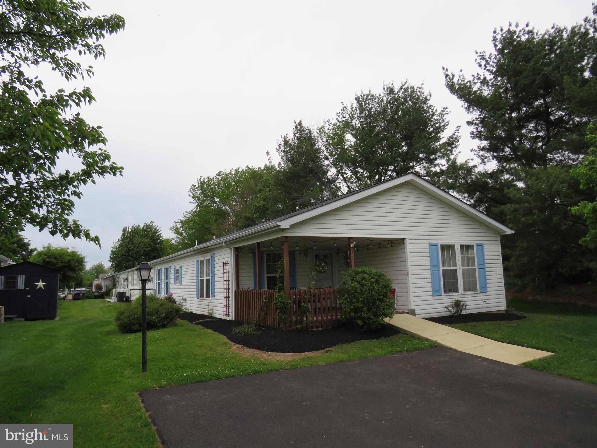 Welcome to the vibrant 55+ community of Villages of Buckingham Springs! This well-maintained Gwynedd model offers comfort, convenience, and great potential to make it your own.

A ramp leads you to a spacious covered front porch—an ideal spot to relax and enjoy the peaceful surroundings. Inside, you’re greeted by a generous formal living room with easy access to the hallway, a second bedroom, and a full hall bathroom located at the front of the home.

Continuing through, you’ll find a conveniently located laundry room with access to the side deck and a nearby storage shed. The main living area features an inviting kitchen with a breakfast bar, seamlessly flowing into the formal dining room and cozy family room—perfect for everyday living and entertaining.

Just off the dining room is the primary suite, complete with dual closets and a private en-suite bathroom featuring a soaking tub, separate shower, and a large double vanity.

Engineered wood flooring extends throughout most of the home, adding warmth and style. Major updates include a newer HVAC system and hot water heater (2019), as well as a roof replacement in 2017.

This home presents a fantastic and affordable opportunity to downsize while adding your personal touch. Seller is motivated to get this home SOLD