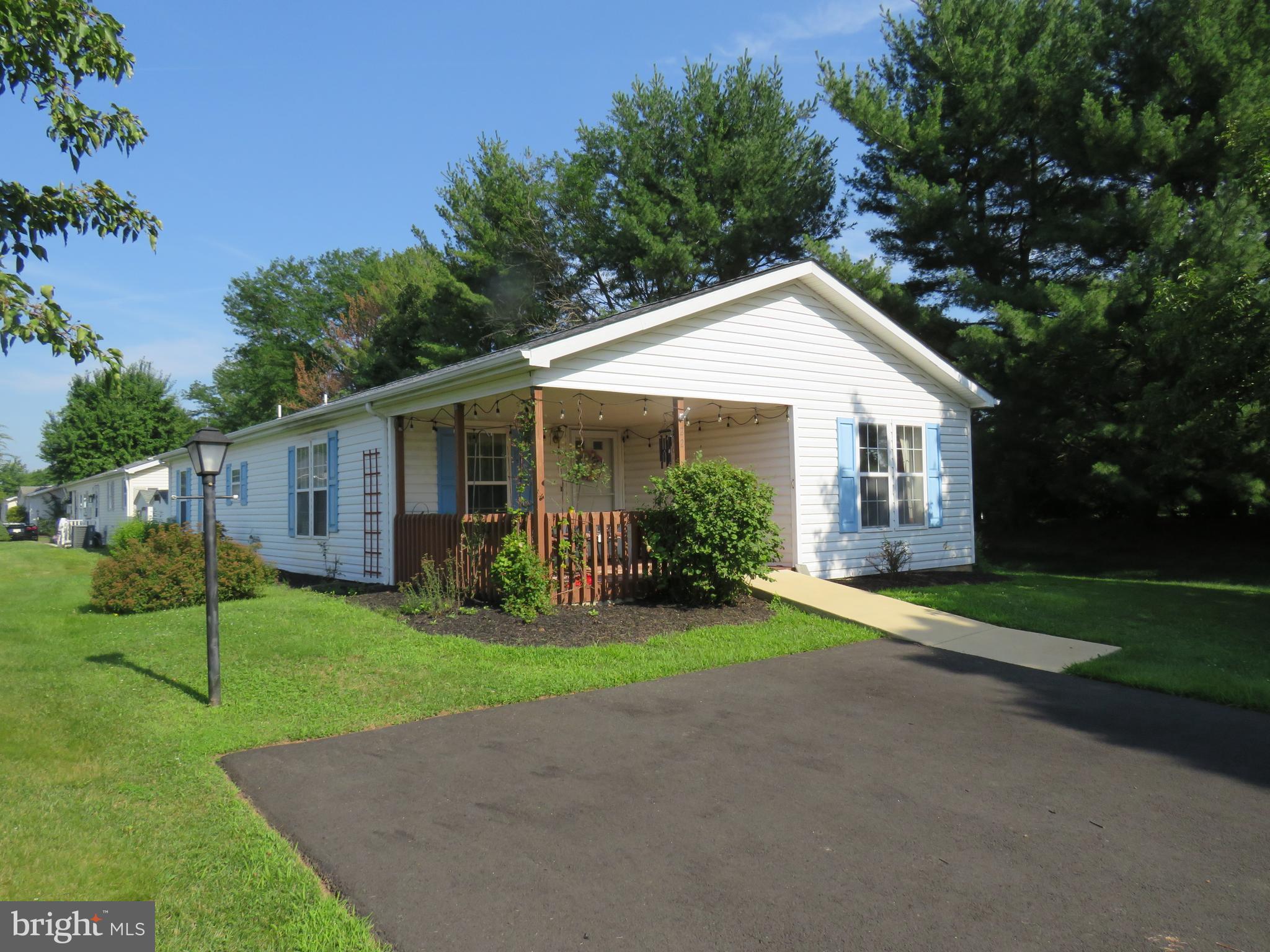 Welcome to the vibrant 55+ community of Villages of Buckingham Springs! This well-maintained Gwynedd model offers comfort, convenience, and great potential to make it your own.

A ramp leads you to a spacious covered front porch—an ideal spot to relax and enjoy the peaceful surroundings. Inside, you’re greeted by a generous formal living room with easy access to the hallway, a second bedroom, and a full hall bathroom located at the front of the home.

Continuing through, you’ll find a conveniently located laundry room with access to the side deck and a nearby storage shed. The main living area features an inviting kitchen with a breakfast bar, seamlessly flowing into the formal dining room and cozy family room—perfect for everyday living and entertaining.

Just off the dining room is the primary suite, complete with dual closets and a private en-suite bathroom featuring a soaking tub, separate shower, and a large double vanity.

Engineered wood flooring extends throughout most of the home, adding warmth and style. Major updates include a newer HVAC system and hot water heater (2019), as well as a roof replacement in 2017.

This home presents a fantastic and affordable opportunity to downsize while adding your personal touch. Seller is motivated to get this home SOLD