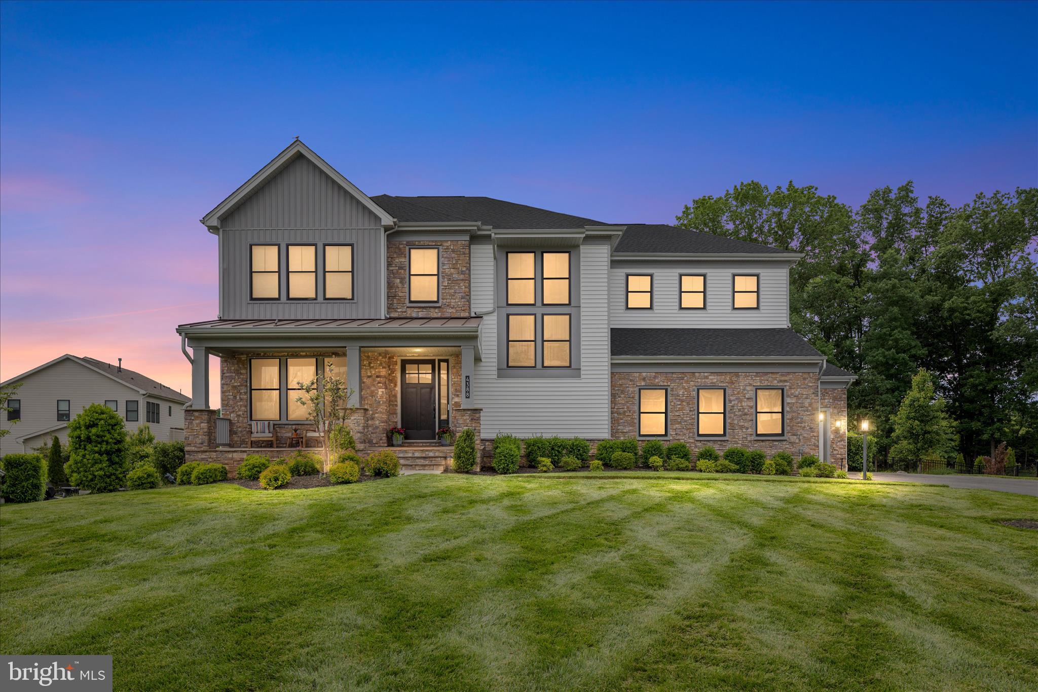 **Priced at Appraised Value**Over $470K in Upgrades & Improvements!**See Upgrades & Improvements List in MLS Documents**
Welcome to 4388 Despain Place, a truly exceptional modern farmhouse in the prestigious gated community of Dominion Valley Country Club. Built by Toll Brothers and one of only 16 highly sought-after Reston models in the neighborhood, this home offers a rare opportunity to own a distinctive residence that seamlessly blends elevated design, everyday functionality, and resort-style living. This well-appointed home, built in 2019, showcases a contemporary architectural style with clean lines, refined trim, steep gables, and striking metal roof accents. Perfectly positioned on a private 0.73-acre cul-de-sac lot, it offers over 6,100 square feet of thoughtfully designed living space, ideal for both grand-scale entertaining and comfortable everyday living. From the moment you arrive, the inviting front porch and striking black windows set the tone for the sophisticated style found throughout. Inside, soaring 10-foot ceilings on the main level, solid wood doors, wide-plank engineered hardwood flooring, and a light-filled open floor plan create a seamless flow. At the heart of the home is the expansive gourmet kitchen, featuring a dramatic quartz island with seating, stacked cabinetry, designer tile backsplash, gas cooktop with stainless steel hood, under-cabinet lighting, and a picture window overlooking the backyard oasis. A fully renovated walk-in pantry with custom built-ins, quartz counters, and a beverage refrigerator keeps everything organized, while the butler’s pantry connects effortlessly to the elegant formal dining room with a tray ceiling and crown molding. The family room offers a warm yet refined gathering space with a gas fireplace and a dramatic sliding door system that opens to a two-story outdoor living area complete with retractable screens and tile flooring, creating the ultimate indoor-outdoor experience. Additional main-level highlights include a stylish mudroom with custom built-ins and a private office with glass doors, ideal for a guest suite or multi-generational living. Upstairs, a spacious loft provides additional living space, while the luxurious primary suite, accessed through a niche entry, features a tray ceiling, abundant natural light, and a spa-inspired bath with a freestanding soaking tub, oversized frameless glass shower, dual vanities, and exceptional storage. Secondary bedrooms are generously sized with custom closet systems, including a private en-suite and a thoughtfully designed shared bath with separate vanity areas, and the upper-level laundry room adds convenience. The fully finished walk-out lower level is designed for versatility and entertaining, offering a large recreation area, a fully equipped second kitchen with granite counters and full-size appliances, a fifth bedroom, full bath, walk-in pantry, and additional storage. Outside, the private backyard retreat features a custom in-ground gunite salt water infinity edge pool with a sun shelf and heater,  an expansive paver patio, hot tub, and multiple gathering areas, along with a built-in stone wood-burning fireplace and professional landscaping that enhances privacy and beauty. Additional highlights include a three-car garage with a storage lift system, extended driveway, Tesla charger, solar panels, whole-house surge protector, and water softener. Residents of Dominion Valley Country Club enjoy access to a championship golf course, renovated clubhouse, fitness center, indoor and outdoor pools, tennis and pickleball courts, scenic trails, and more, all conveniently located near major commuter routes, shopping, dining, wineries, and breweries. This is more than a home. It is a lifestyle.