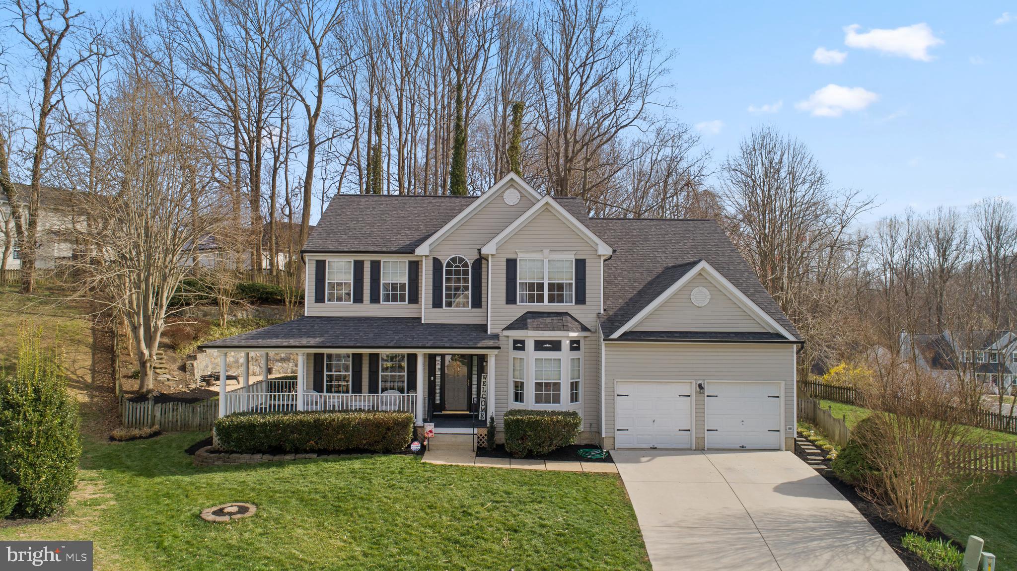 Tucked away on a quiet cul-de-sac in sought-after Chesapeake Beach, this home offers a comfortable blend of space, function, and location—just a 3-minute drive to the Chesapeake Bay. Enjoy easy access to waterfront dining, local restaurants, and entertainment, all while coming home to a peaceful setting. The property features 5 bedrooms, 3.5 bathrooms, and a custom-built gunite pool.

A covered front porch that wraps around the side of the home creates a welcoming first impression and offers multiple places to relax at the start or end of the day. Inside, hardwood floors carry through the main level, complemented by natural light that gives the home an open, inviting feel. The foyer features a thoughtfully designed staircase that is set off to the side, creating a more open and welcoming entry rather than having the stairs directly in front of you as you walk in. The layout continues with flexibility in mind, offering a sitting room or office with a reading nook, a spacious family room, a formal dining area, and a central living space anchored by a fireplace.

The kitchen is well-positioned as the hub of the home, featuring stainless steel appliances, dark countertops, white cabinetry, and two breakfast bars for casual meals or conversation. It opens to a bright dining or sitting area that looks out over the backyard, creating an easy connection between indoor and outdoor living.

Upstairs, four bedrooms provide comfortable accommodations, including the owner’s suite with dual closets and a private bath complete with a soaking tub, walk-in shower, and double vanity.

The finished basement expands the home’s versatility with a living area, bar, and full bathroom—well-suited for guests, extended stays, or a separate entertaining space. It also includes a partially finished room currently being used as a bedroom, offering flexibility for future use. A double-width walk-up areaway provides convenient access to the backyard and a more open, functional entry compared to a typical single-width design.

Out back, the setting is designed for both relaxation and gathering. The deck overlooks a custom gunite pool, surrounded by a concrete patio and custom-designed stone retaining walls that define the space and add structure to the landscape. A bridge extends from the main yard to a fully fenced rear yard, connecting to a separate grassy area with a playground—adding both function and a unique touch to the outdoor space.

With an attached garage, a quiet cul-de-sac location, and close proximity to the water, this home brings together everyday comfort and the lifestyle that makes Chesapeake Beach such a desirable place to live.
