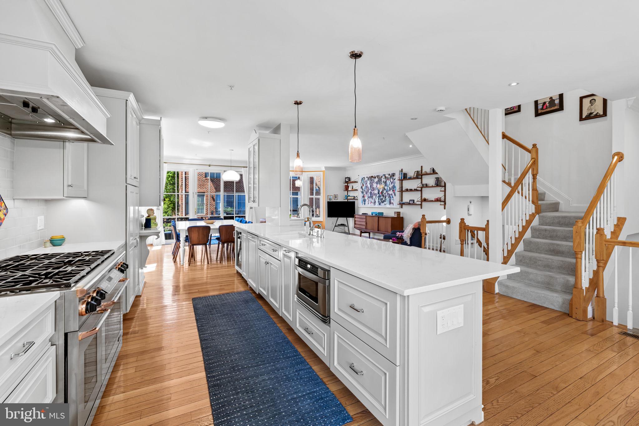 Step into this beautifully appointed end-of-row townhouse offering 3 bedrooms and 4.5 bathrooms in the highly desirable North Shore community. As the largest model available, this home delivers exceptional space and comfort, enhanced by an abundance of natural light streaming through oversized windows throughout.

The entry level welcomes you with a full bath and a convenient wet bar—perfect for entertaining, hosting guests, or creating a flexible bonus living area. Upstairs, the main level showcases a fully open floor plan featuring a seamless flow between the kitchen, living room, and dining area, creating an ideal space for both everyday living and gatherings. The kitchen stands out with high-end appliances, generous counter space, and a layout designed for effortless entertaining.

The top-floor primary suite offers a private retreat with a beautifully updated bathroom, complete with a walk-in shower, soaking tub, and a spacious walk-in closet. Two additional bedrooms, along with a dedicated office, provide plenty of flexibility for family, guests, or working from home.

A two-car garage with interior access adds everyday convenience, along with additional storage space.

Spacious, light-filled, and thoughtfully designed, this is truly a spectacular property offering the perfect blend of modern living and prime location—an opportunity you won’t want to miss.