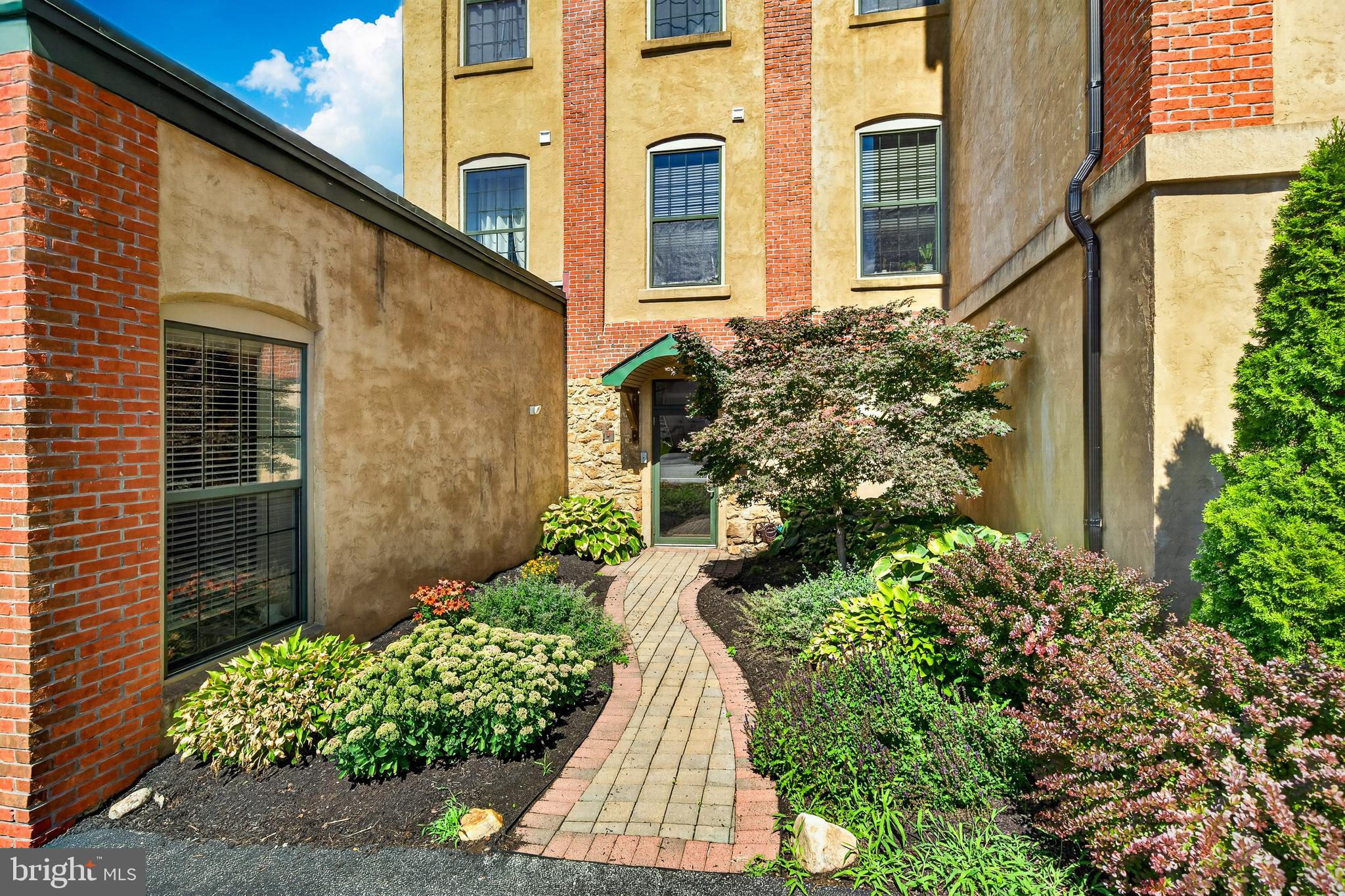 Welcome to Washington Mill Lofts where historic character meets modern loft-style living in the heart of downtown Phoenixville. This unique condominium community, thoughtfully converted from the historic Davies’ Perseverance Knitting Mill, offers the perfect blend of original architectural details and contemporary conveniences.  Unit #202 is a charming and spacious one-bedroom loft featuring an open-concept layout, soaring ceilings, and oversized factory-style windows that fill the home with natural light. The beautifully preserved hardwood floors and industrial-inspired details create a warm, inviting atmosphere that makes this home truly one-of-a-kind. The updated kitchen is designed for both everyday living and entertaining, featuring updated stainless appliances (2023), 42” cabinetry, and a breakfast bar. The open living and dining area provides a flexible space to relax, host friends, or enjoy the unique loft aesthetic.  The generously sized bedroom offers excellent closet space and a second entrance for added convenience, providing easy access to the parking area.  Sizeable hall closet for all of your storage needs. The full bathroom features ceramic tile finishes, including a tiled tub/shower combination. Additional highlights include in-unit laundry, a secure storage unit in the basement (approximately 16x5), assigned off-street parking, elevator, lobby mailboxes,  and access to the building’s outdoor fenced in courtyard. Located just steps from everything downtown Phoenixville has to offer, you’ll enjoy easy access to acclaimed restaurants, breweries, coffee shops, boutiques, festivals, and entertainment. Outdoor enthusiasts will love being close to the Schuylkill River Trail for walking, running, biking, kayaking, and more. With its unbeatable location, historic charm, and low-maintenance lifestyle, this Unit offers a rare opportunity to own a distinctive loft-style home in one of Phoenixville’s most desirable communities.  Pet restriction addendum available. Showings begin Saturday, July 11th at 12 Noon.  Professional photos will be available by Friday, July 10th.