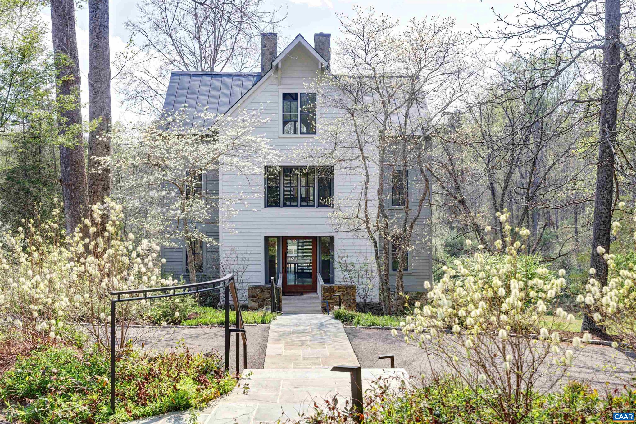 With dramatic and visually striking architectural quality, the Mill House sits in a park-like setting on almost 5 acres on Ivy Creek, just minutes west of Charlottesville. Built in 1994, the home was thoroughly renovated to the highest standards by Alexander-Nicholson in 2018.  Main level includes living room with FP, gourmet kitchen with top of the line everything, and a dining area with permanently protected views across the creek.  2nd floor is primary bedroom suite plus private sitting room/office.  3rd floor includes two additional bedrooms, each with its own renovated bath, as well as a comfortable sitting area for reading or TV.  A 3-stop elevator means that most parts of the home are easily and comfortably accessible.  The grounds are truly amazing, with 825 ft of creek frontage, 3 acres of flat ground, gorgeous trees, and a delightful firepit seating area.  5-minute drive to Charlottesville, in an established neighborhood of other fine homes.,Marble Counter,Fireplace in Family Room,Fireplace in Living Room,Fireplace in Study/Library