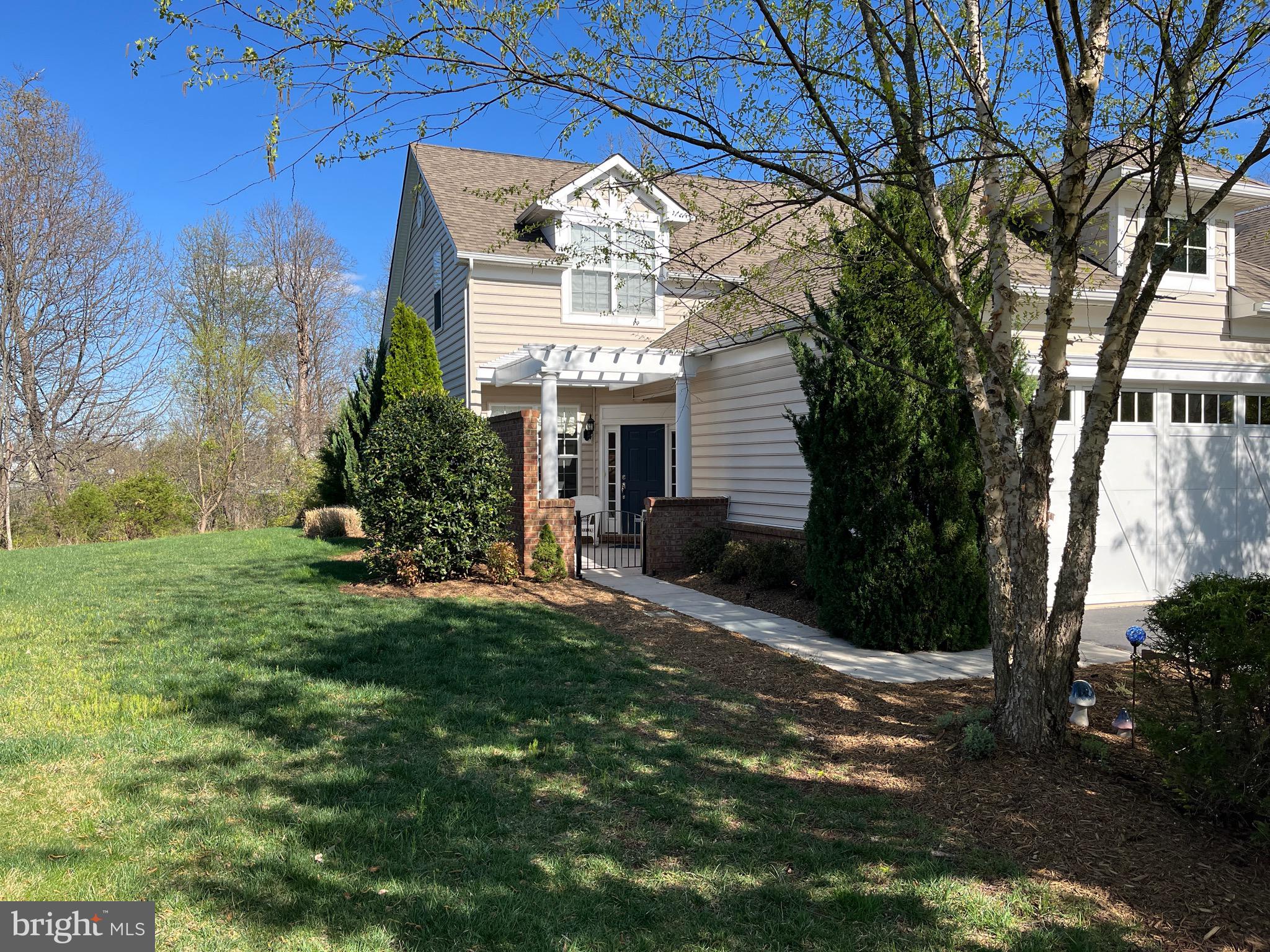 Beautiful End unit 3 bedroom 2.5 bathroom townhouse in 55+ gated community.  Master level bedroom and bathroom on main level. Hardwood floors on main level, gourmet kitchen with upgraded cabinetry, stainless steel appliances, and nice crown molding are among the features of the property. Backs to nice woods and open back yard. Upper level spacious bedrooms and nice sitting area. Large two car garage. Community offers indoor and outdoor swimming pool, transportation service, close to  One Loudoun town center and walking and jogging trails. Community center offers exercise room, club house, billiard room, and fitness center. All exterior maintenance done by condo so easy retirement living.  Well maintained by homeowners so a MUST SEE!