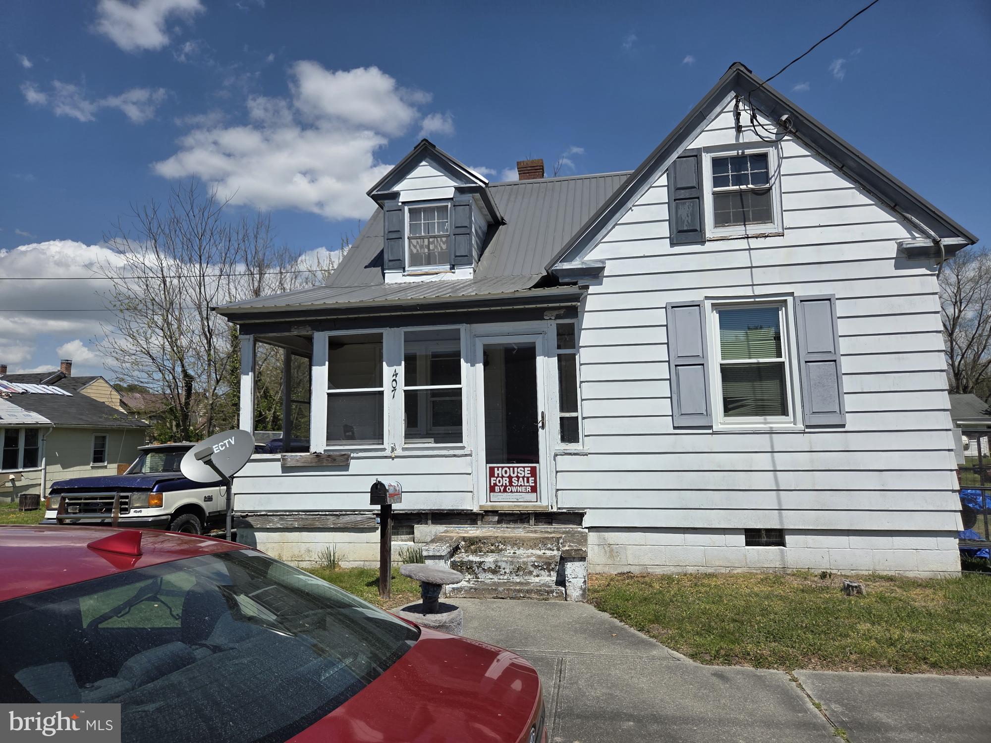 Situated on a double lot with additional adjacent buildable lot included in the sale. new roof, many windows recently replaced, enclosed porch, 3 sheds, and a large detached 2 car garage.
