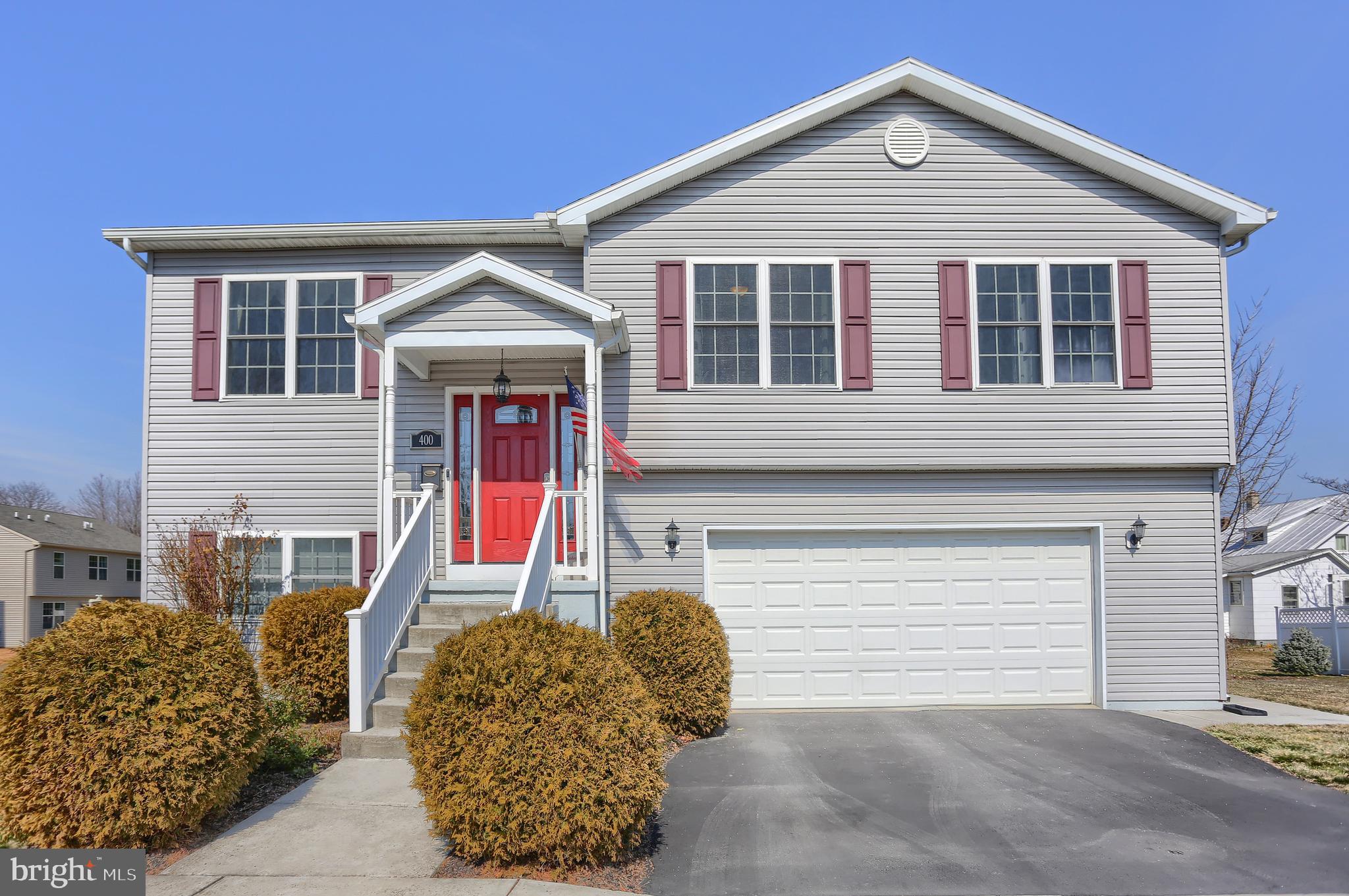 A RARE FIND in the remarkable location of Mechanicsburg Borough!  "Picture Perfect" and "Best in Every Way" describes this meticulously maintained home. Admire the beauty of this newer bi-level built in 2011, featuring 4 bedrooms & 3 full baths. Admire the stunning kitchen with beautiful cabinetry, quartz countertops, Chiaro travertine backsplash, stainless steel appliances, center Island, and new luxury vinyl plank flooring that flows through the dining area and living room. The dining area has beautiful custom Kraftmaid cabinetry with plentiful storage & luminous natural light throughout the main floor. Lots of storage. Open the sliding patio doors and step out to a new Trex deck that is ideal for outdoor enjoyment. The kitchen opens to an inviting family room that features a tranquil stacked stone gas fireplace - exceptional space for relaxing & entertaining. To complete the main level is a well-appointed owner's suite with soaking tub and walk-in shower, charming second & third bedrooms, and a tasteful second full bath. Walk down the steps and shut the door to your own private retreat with another full en-suite bath. This multi-use room can be used as a 4th bedroom, office, or home gym. The exposed walkout to the lower Trex deck leads to a spacious fenced side yard to be enjoyed by all. Spacious oversized 2 car garage. Walking distance to schools, and a lovely stroll will lead you to downtown shops & dining.  EXQUISITE CONDITION, DO NOT MISS!