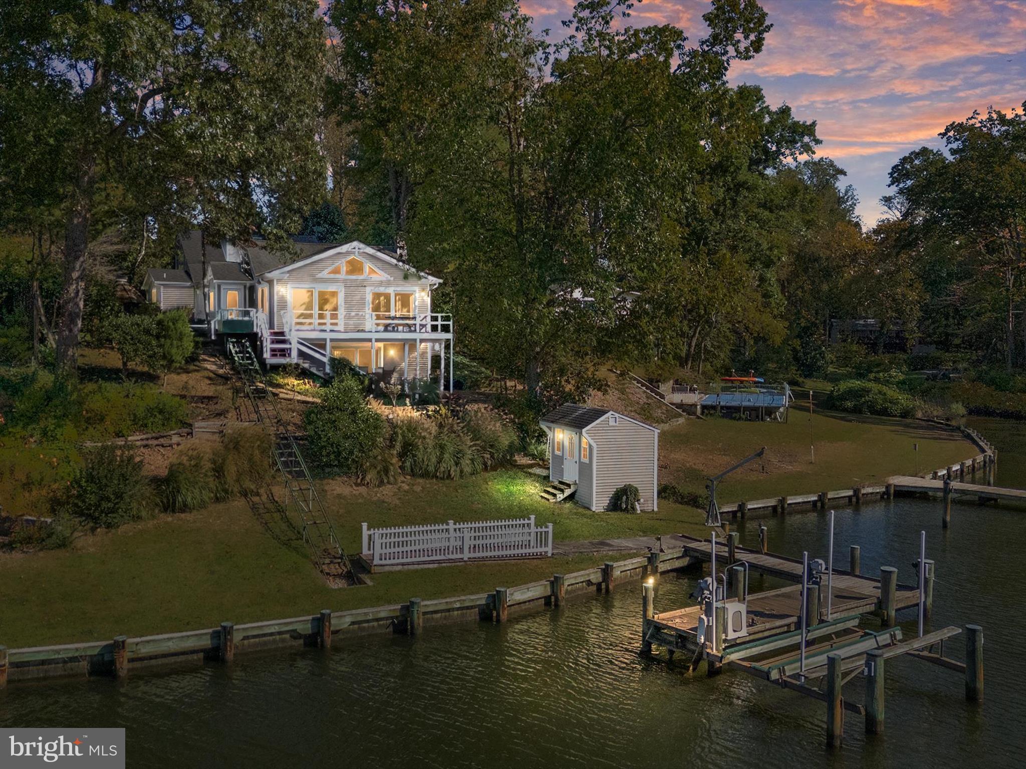 Enjoy amazing sunsets over the South River from this waterfront retreat overlooking Spring Lake. This 3-bedroom, 4-bath home is thoughtfully designed for comfort, convenience, and the ultimate waterfront lifestyle. The property features a large deck and a private dock with 4’ MLW, complete with a boat lift, two additional slips, and a boat davit—ideal for boating enthusiasts. A shed with electric service provides storage for all your gear.

Inside, the recently updated kitchen offers granite countertops, stainless steel appliances, and elegant glass-front cabinetry. The spacious primary suite features a luxury bath with heated floors. Practical touches include two sets of washers and dryers, a residential elevator, and an electric tram providing easy access down to the water. Private Financing is Available for this house. Rates and terms apply.
Additional highlights include a paver driveway with parking for 4–6 cars, a whole-house propane generator, warm oil heat with hot water baseboard, plus two heat pumps and a split-zone system for year-round comfort.
Located in a water-privileged community, enjoy access to a boat ramp, community dock with pavilion, and playground—perfect for gatherings and events. Whether you’re relaxing on the deck, entertaining, or spending time on the water, this home offers the best of the South River lifestyle.