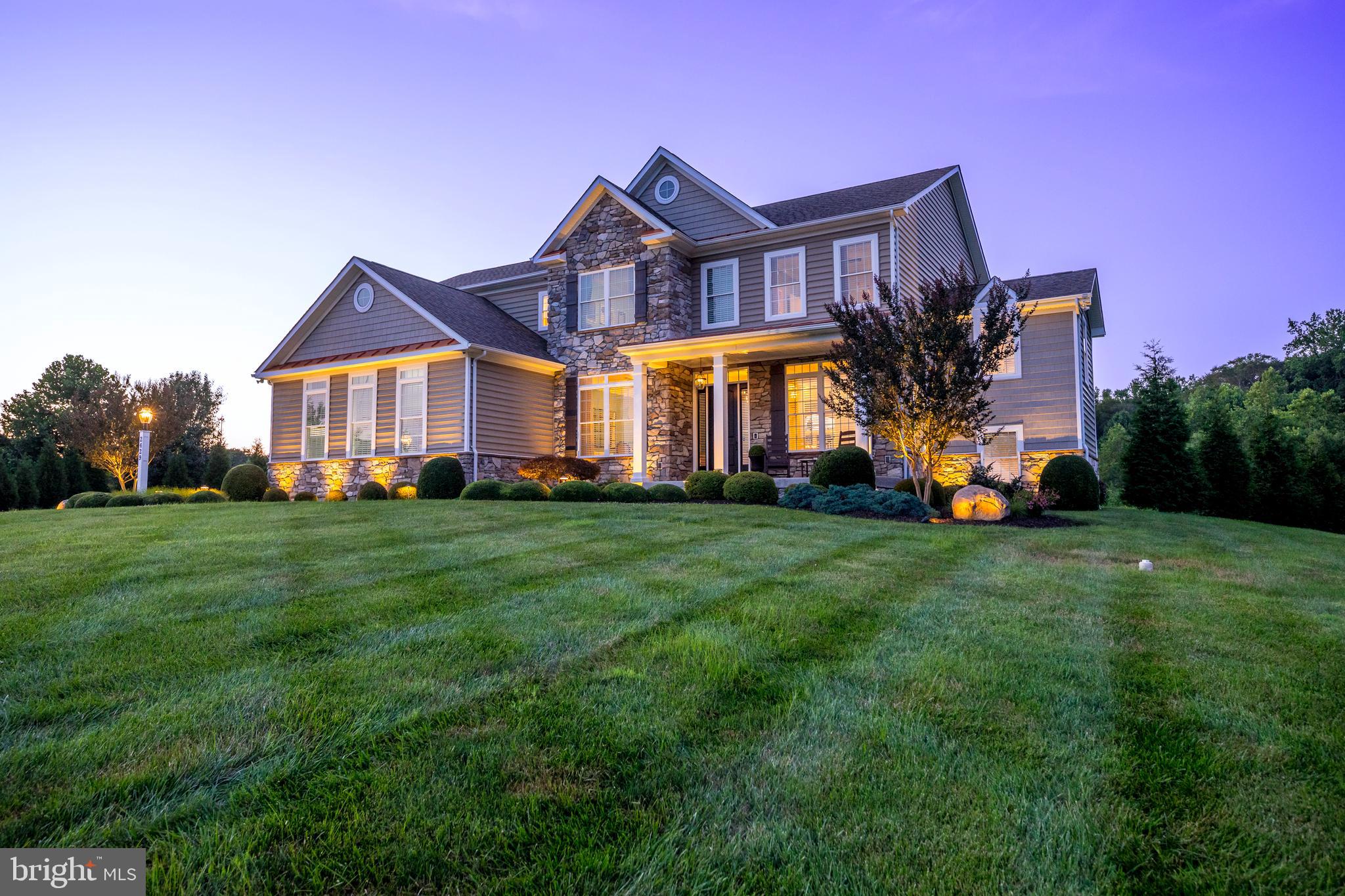 Nestled on a private 2.23-acre wooded homesite backing to protected forest conservation land and open space, this exceptional Clark Turner custom residence offers a rare combination of luxury craftsmanship, resort-style outdoor living, and unmatched privacy—all with no HOA.

From the moment you arrive, the professionally designed landscaping, architectural lighting, and inviting covered front porch create a memorable first impression. Inside, timeless architecture meets modern luxury with 10-foot ceilings on the main level, 9-foot ceilings upstairs, oversized windows with transoms, 8-foot doors, wide-plank hardwood flooring, extensive crown molding, and remarkable custom ceiling details including a diamond coffered Great Room, shiplap kitchen, barrel-vaulted morning room, groin-vault powder room, and a tray ceiling with LED accent lighting in the luxurious primary suite.

Designed for both everyday living and entertaining, the gourmet chef’s kitchen is the heart of the home. Premium Jenn-Air commercial-style appliances include a built-in refrigerator, built-in coffee system, 48-inch gas range with double ovens and electric griddle, under-counter microwave, farmhouse sink, secondary prep sink, custom stainless vent hood, full-height tile backsplash, under-cabinet lighting, and an adjoining dry bar with beverage center. A private home office, dedicated fitness room, custom mudroom with built-in cubbies, and an unfinished basement with 9-foot ceilings offering exceptional storage and future expansion complete the thoughtfully designed floor plan.

The spacious primary suite serves as a private retreat featuring a spa-inspired bath with a soaking tub, oversized frameless glass shower with rainfall, handheld and primary shower heads, dual granite vanities, private water closet, and a custom walk-in closet with premium built-in organization, three-way mirror, and designer lighting.

The backyard is the true centerpiece of this remarkable property—a professionally designed outdoor living space that rivals a private resort. A custom-built 20’ x 22’ pavilion features Bromic infrared heaters, ceiling fans, recessed lighting, LED accent lighting, surround sound, and a 75-inch television for year-round enjoyment. The resort-style outdoor kitchen is appointed with granite countertops, a Blaze Professional grill, side burner, Lynx warming drawer, dual refrigerators, built-in ice chests, abundant storage, and every convenience for effortless entertaining. A sprawling paver patio showcases a custom propane fire pit, two-tier sitting wall, integrated landscape speakers, and over 75 professionally designed LED uplights, spotlights, deck lights, and hardscape lights, creating a spectacular evening ambiance. A large composite deck with waterfall staircase and a dramatic two-sided stone fireplace seamlessly connects the home’s interior to the outdoor living spaces. Designed for effortless entertaining, these interconnected outdoor spaces have comfortably hosted gatherings of more than 60 guests.

Luxury extends well beyond the finishes with a three-zone geothermal HVAC system, whole-house water treatment system with reverse osmosis drinking water supplied to both a dedicated faucet and refrigerator, professionally wired 12-zone Sonos whole-home audio system, Polk Audio invisible 7.1 surround sound theater with in-floor subwoofer, hardwired security system, eight-camera NVR surveillance system, and an oversized finished three-car garage with professionally coated floors, utility sink, and additional storage.

Offering an extraordinary blend of architectural craftsmanship, modern technology, exceptional privacy, and resort-style amenities rarely found in today’s market, 2429 Creswell Drive is more than a home—it’s a lifestyle.