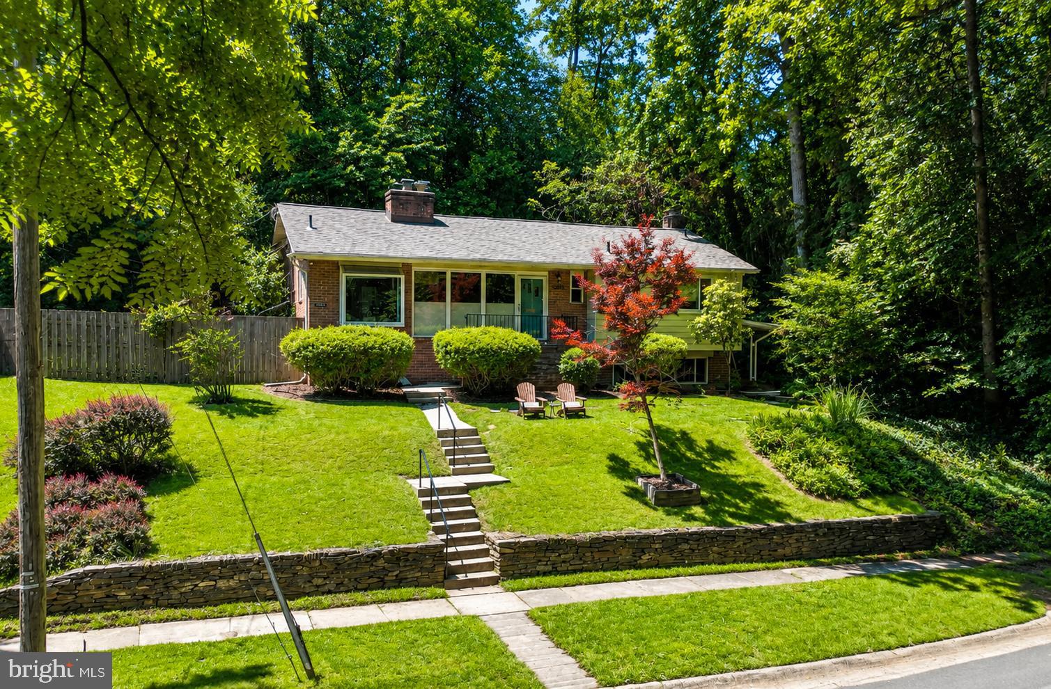 Don't hike to this property, run.

Tucked away at the end of a quiet street with the Northwest Branch Trailhead and a babbling stream just outside the front door, this mid-century modern retreat offers a lifestyle that is increasingly hard to find. Surrounded by nature yet minutes from Metro, shopping, dining, and major commuter routes, this 4-bedroom, 3-bath home is the perfect balance of privacy and convenience.

Inside, timeless mid-century design shines through vaulted ceilings with exposed wood beams, hardwood floors throughout the main level, and walls of windows that flood the home with natural light. The spacious living room centers around a cozy fireplace, while the beautifully updated tiled sunroom creates the perfect space to relax and enjoy the changing seasons. The bright kitchen features granite countertops, a gas stove, side-by-side refrigerator with ice maker and water filter, and a charming window seat overlooking the wooded ravine.

The Forest Knolls Pool is a beloved neighborhood amenity and a favorite destination for residents during the summer months. Its convenient location and strong sense of community make it one of the area's most cherished features.

The recently renovated garden-level suite offers exceptional flexibility with its own private entrance, kitchenette, built-in workspaces for two, full bath, and separate living area, making it ideal for guests, extended family, remote work, or potential income opportunities.

Step outside to enjoy the deck and patio overlooking mature trees and lush landscaping. In the spring, the property comes alive with colorful azaleas and daffodils. Whether you're enjoying your morning coffee while listening to the stream, hiking or biking miles of nearby trails, or simply unwinding in the peaceful surroundings, this home feels like a private nature preserve.

Located within walking distance of Forest Knolls Elementary School, Forest Knolls Community Pool, and North Four Corners Park, and just minutes from Trader Joe's, Safeway, Woodmoor Shopping Center, downtown Silver Spring, and both the Silver Spring and Forest Glen Metro stations. Easy access to I-495, Colesville Road, and University Boulevard makes commuting a breeze.

A rare opportunity to own a distinctive mid-century modern home where nature begins at your front door and every day feels like a getaway.