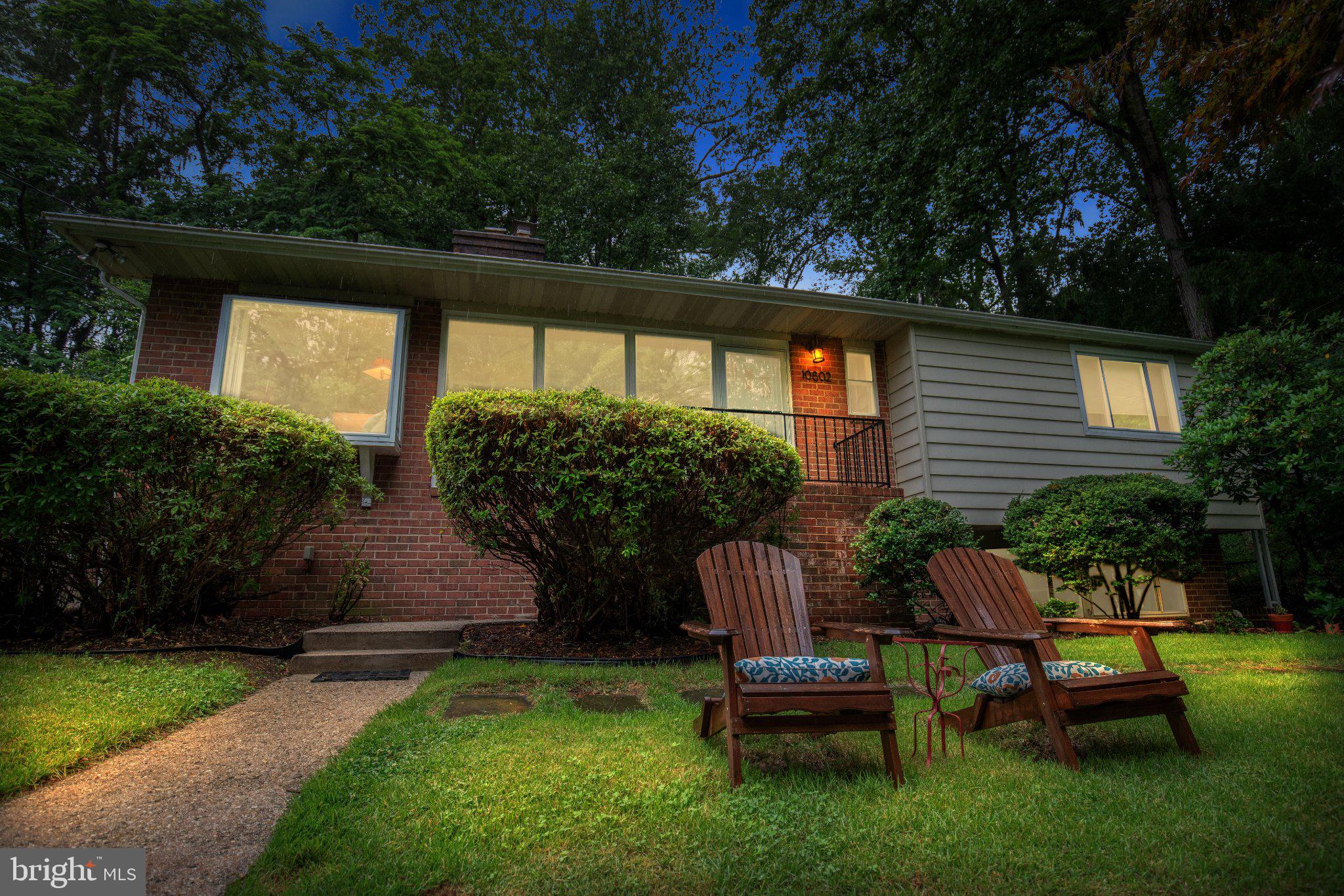 Don't hike to this property, run. Two living spaces. Two kitchens. One great home.

Tucked away at the end of a quiet street with the Northwest Branch Trailhead and a babbling stream just outside the front door, this mid-century modern retreat offers a lifestyle that is increasingly hard to find. Surrounded by nature yet minutes from Metro, shopping, dining, and major commuter routes, this 4-bedroom, 3-bath home is the perfect balance of privacy and convenience.

Inside, timeless mid-century design shines through vaulted ceilings with exposed wood beams, hardwood floors throughout the main level, and walls of windows that flood the home with natural light. The spacious living room centers around a cozy fireplace, while the beautifully updated tiled sunroom creates the perfect space to relax and enjoy the changing seasons. The bright kitchen features granite countertops, a gas stove, side-by-side refrigerator with ice maker and water filter, and a charming window seat overlooking the wooded ravine.

The Forest Knolls Pool is a beloved neighborhood amenity and a favorite destination for residents during the summer months. Its convenient location and strong sense of community make it one of the area's most cherished features.

The recently renovated garden-level suite offers exceptional flexibility with its own entrance, kitchenette, built-in workspaces for two, full bath, and separate living area, making it ideal for guests, extended family, remote work, or potential income opportunities.

Step outside to enjoy the deck and patio overlooking mature trees and lush landscaping. In the spring, the property comes alive with colorful azaleas and daffodils. Whether you're enjoying your morning coffee while listening to the stream, hiking or biking miles of nearby trails, or simply unwinding in the peaceful surroundings, this home feels like a private nature preserve.

Located within walking distance of Forest Knolls Elementary School, Forest Knolls Community Pool, and North Four Corners Park, and just minutes from Trader Joe's, Safeway, Woodmoor Shopping Center, downtown Silver Spring, and both the Silver Spring and Forest Glen Metro stations. Easy access to I-495, Colesville Road, and University Boulevard makes commuting a breeze.

A rare opportunity to own a distinctive mid-century modern home where nature begins at your front door and every day feels like a getaway.