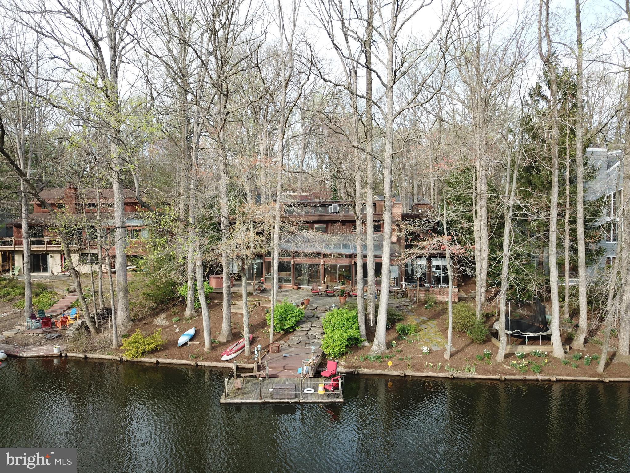 Enjoy amazing waterfront views year 'round on Reston's Lake Thoreau! This is a great opportunity to live on one of the best lots on Lake Thoreau!  Incredible waterfront views are offered throughout the home.  Open floor plan and design. High ceilings, skylights, atrium windows create an open and bright setting.  The home features two levels, and the owner's suite is on the main level and has a vaulted ceiling, brick fireplace, built-ins and sliding glass doors leading to the deck, patio and lake.  The living room and dining room open to the "lake room", which features a granite wet bar, skylights, a stone fireplace, and sliding glass doors leading to the stone patio, lake and your private dock and floating dock boat! The kitchen features cork floors, granite counters, stainless steel appliances and gas cooking - including a griddle and grill! The laundry room is also on the main level as well as a recreation room/bonus room.  Three additional bedrooms and two full baths are located on the upper level.  The home is beautifully situated on the lake, and is also convenient to all of Reston's amenities including pools, and tennis courts (just steps away!) and less than a mile from the Wiehle Avenue Silver Line Metro.  For convenience to the trails, shopping and restaurants and major commuter routes - this spot is awesome!  Vacation 24/7!