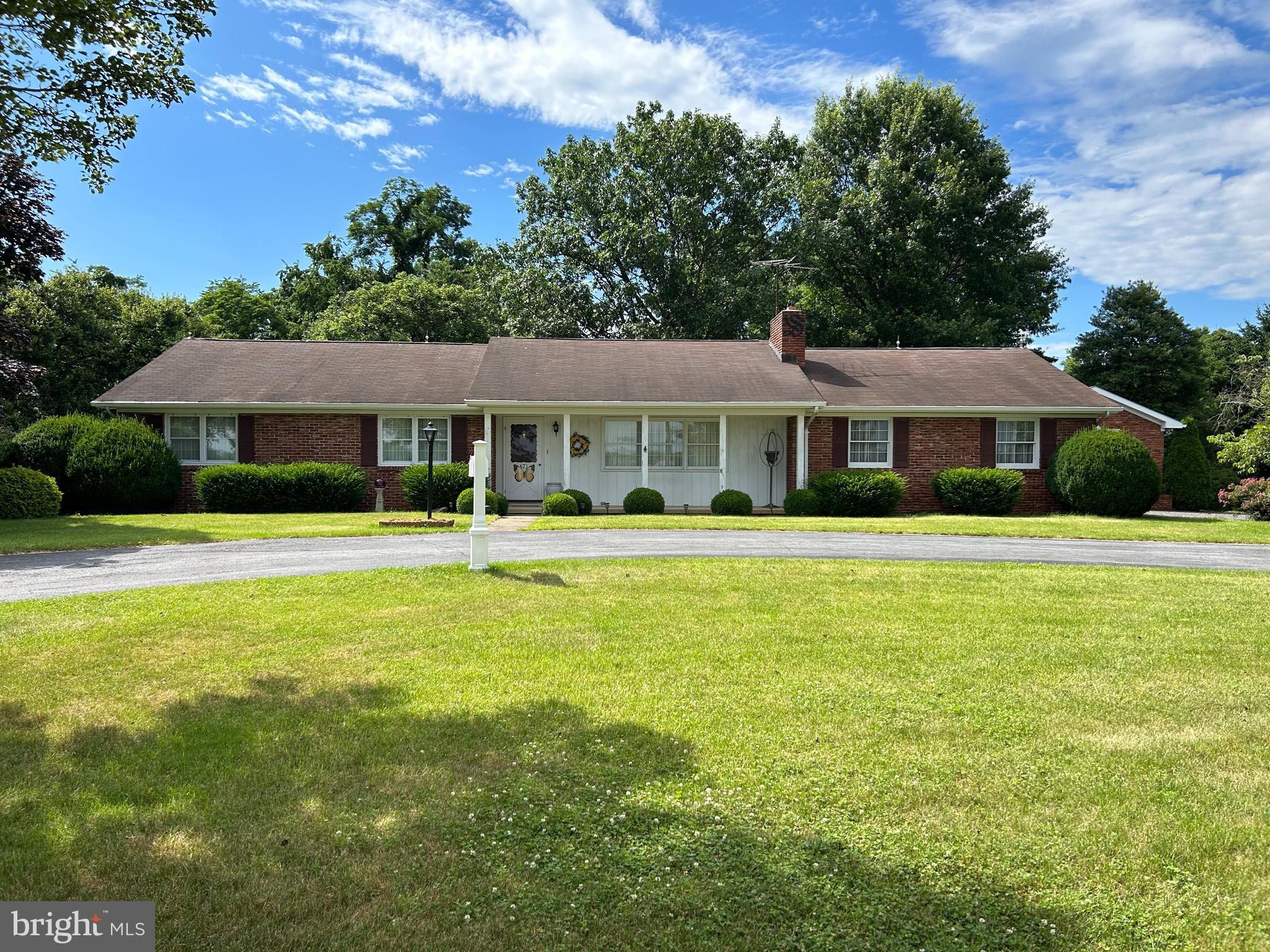 Beautiful large all brick rancher perched on 3.76 artfully landscaped acres in the rolling hills of west Berkeley County. The lot includes a large exterior farm shed and another large equiptment garage. Welcomed by a circular driveway, this amazing homestead is unrestricted and directly across the street from Amani Brewery.  The house has gleaming hardwood floors, fireplace, family room, office, living room, kitchen, 3 bedrooms, large attached 2 car garage, and new windows.  Finished hobby room in the basement and huge workshop.  This property is pending s/d from a larger existing parcel.  This parcel is to be designated as lot 6.  Pill and Pill to be closing attorney for this transaction.  See photo description.