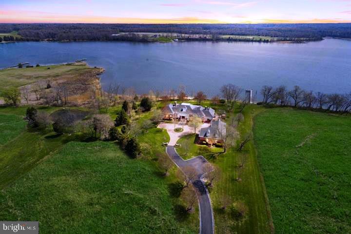 This custom estate known as Hunters Rest consists of 22 waterfront acres and is one of the most beautiful properties in all of Southern Maryland.  This  8000 plus square foot home was custom built to the highest standards available and thoughtfully crafted.  The home  was designed for entertaining and offers a large gourmet kitchen with granite, stainless, two islands and so much more.  Stunning water views every where you look. The master bedroom is located on the main level with large custom closets and luxurious bathroom. Main level living with three extra rooms downstairs. Five fireplaces, two laundry rooms, movie room upstairs with built in King size Murphy bed.  Phantom executive screen system on large brick porch is ideal for entertaining. Efficient Geo-thermal heating and cooing systems to all custom mill work, you will be impressed.   Private deep-water pier, 720 feet of waterfront, your own barn  and a three car garage are just some of the other amenities this home offers.   Potential for a waterfront pool. If you have to telecommute, this is the place to be!