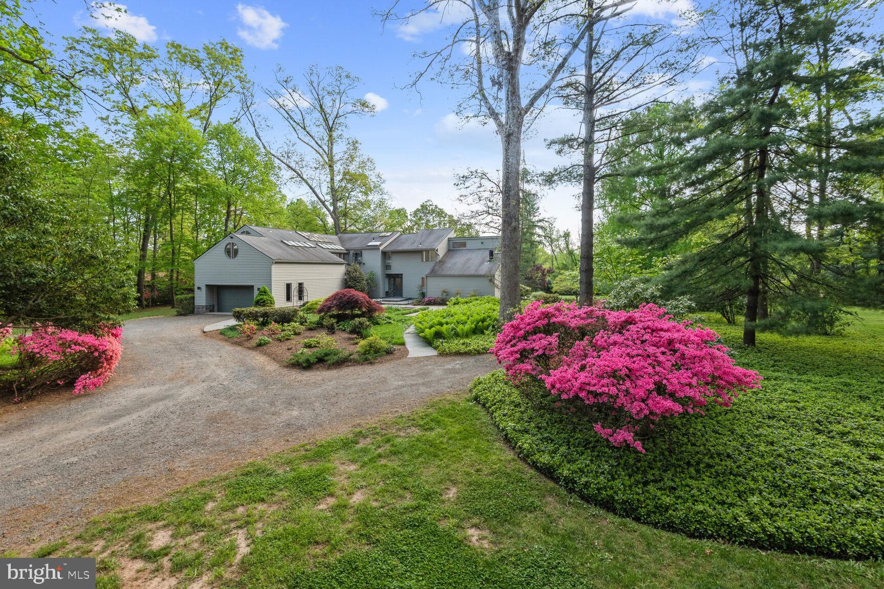 This striking modern home dazzles with an abundance of natural light.  The open flowing floor plan provides for gracious entertaining and convenient family living.  Walls of windows create an indoor-outdoor relationship to the glorious grounds.  Mature trees, blossoming colors and expansive lawn areas transition to hardscapes, gardens, and water features.  The kitchen is a chef's delight, with two full sized ovens and both electric and gas cooktops.  The kitchen is open to the breakfast area, family room w built ins, and a central gas fireplace.  The dining room features walls of glass replete w custom window treatments.  The front entry  way transitions from a open reception area to an expansive living area and a separate office/den/study.  The Primary suite offers his & hers separate full bathrooms (just remodeled), walk in closets (one cedar), dramatic skylights and a special getaway space ideal for yoga/art studio/exercise/other.  Less than a mile from Great Falls center, yet feels so far away. This is a special home and a real value!