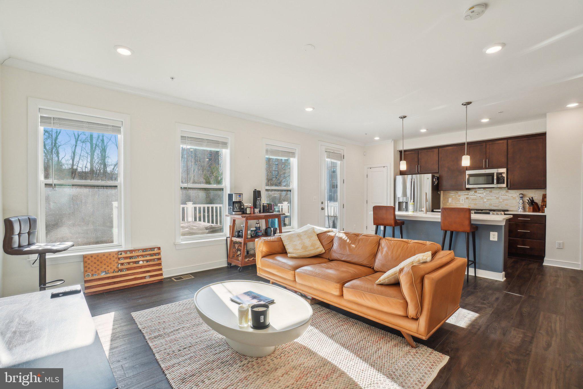 This beautiful open floorplan 4-level 3-bedroom, 2 full bath, 2 half bath townhome is in the heart of Alexandria, close to everything and steps from the Huntington Metro Station. You will love this quiet neighborhood which also has a backyard with views of a wooded area and access to a walking trail. The ground level has a one car garage with a charging station capability for your electric vehicle. The lowest level has a large entertaining area with an electric fireplace, a full wet bar, and a large half bath. You could walk out the patio doors to the common area behind your home. The second level holds the chef’s kitchen with brown cabinets, granite countertops, and gas stove. You can also entertain on your Trex deck that looks out over the treed area. The 3rd level has two large bedrooms and a full bathroom with a shower/tub combo. The upper level has the large main bedroom, walk in closet, and laundry room. The main en suite has a large walk-in shower and a large double vanity sink with room to spread out. Easy access to Old Town and shopping, and I-495/95.  Please note, if additional parking is a concern, monthly parking is available in the nearby Huntington metro garage. Come see this beauty! Park in the community or on Metro view Parkway.