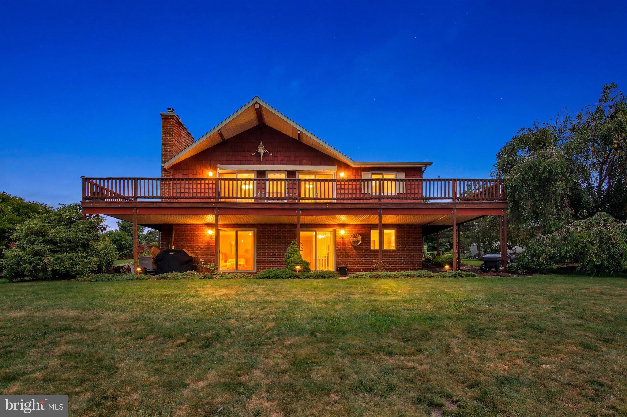 A rare opportunity to own a privately situated lakefront home on a double lot in Lake Heritage, offering approximately 120 feet of water frontage—twice the frontage of many properties in the community. Tucked down a private driveway, the property features an oversized detached garage with a workshop and storage above, mature trees and shrubs, beautiful landscaping, established flower beds, fish ponds, and an impressive dock with a sliding board and parking for two boats.

Custom built for the current owner approximately 42 years ago, this well-loved home offers a unique and flexible layout with two bedrooms on the main level and three additional bedrooms in the full walk-out lower level. The spacious great room features hardwood floors, a cathedral ceiling, and a brick fireplace with a woodstove insert that could be removed to return it to a traditional fireplace. In addition to the three bedrooms, the lower level includes a recreation room, wet bar, pellet stove on a brick hearth, and access to a covered patio overlooking the lake. Both hearths feature convenient exterior wood-loading doors.

A sunroom just off the front entrance and a large rear deck provide wonderful places to relax and enjoy the lake views. The home has been well maintained and offers plenty of potential for a new owner to update and customize it to their taste. Improvements completed over the last several years include the roof, central air conditioning outdoor unit, hot water heater, and electrical upgrades.

The exceptional double lot is what truly sets this property apart. Lakefront property in Lake Heritage is highly sought after, and opportunities offering this much water frontage, privacy, dock space, and room to enjoy the lake are rarely available.