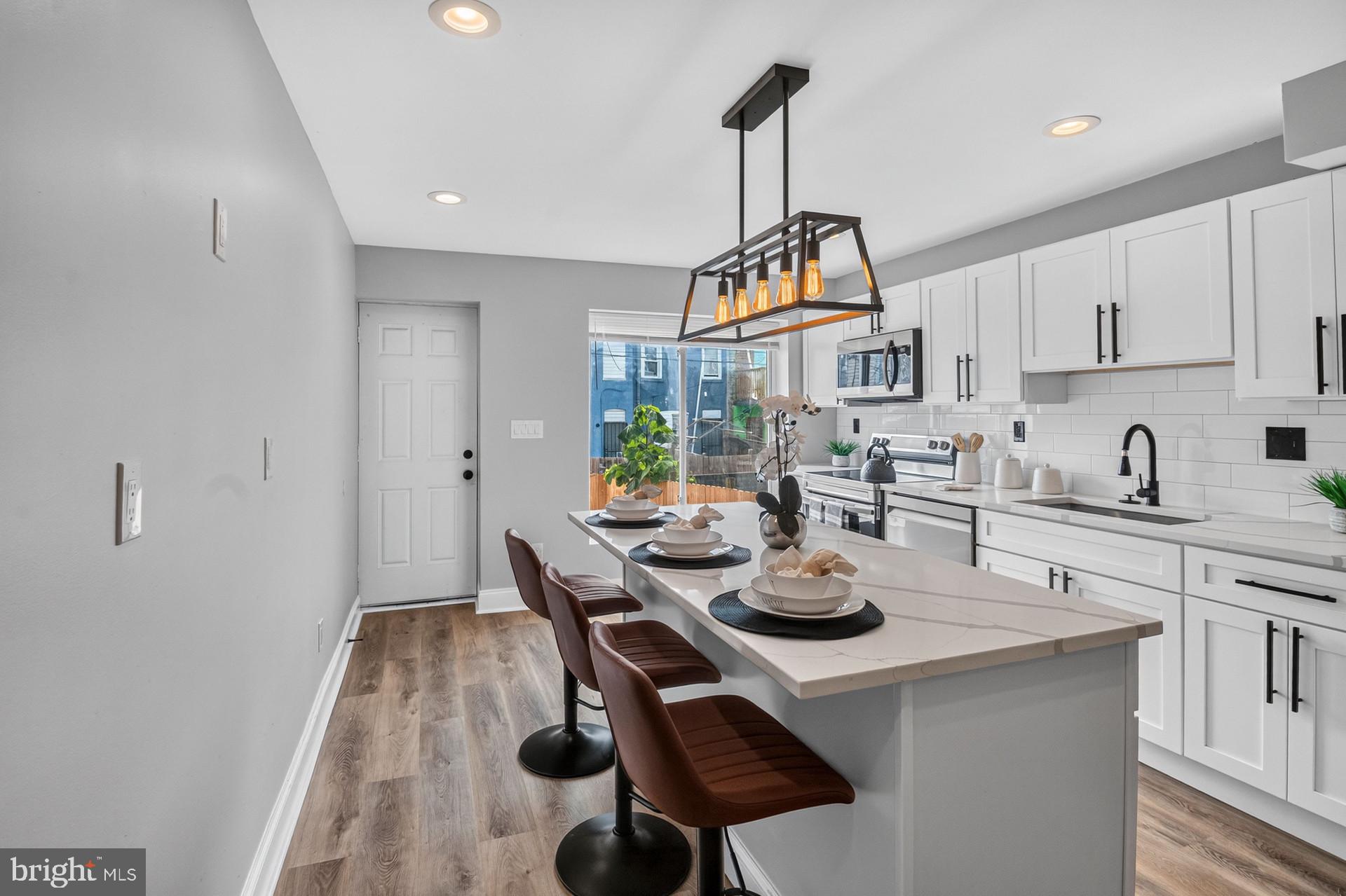 Step into a world of refined elegance and modern comfort in this beautifully renovated interior row townhouse, a true gem that has been meticulously updated to meet the highest standards of luxury living. With a complete renovation slated for 2026, this residence seamlessly blends classic charm with contemporary sophistication, offering an exclusive lifestyle that is both inviting and functional. The engineered wood and laminate plank flooring throughout exudes warmth and style, creating a cozy atmosphere that feels like home. Large double-hung windows bathe the space in natural light, enhancing the inviting ambiance. The heart of the home is the gourmet kitchen, equipped with energy-efficient appliances, including a built-in microwave, self-cleaning oven, and a sleek refrigerator. The thoughtful design ensures that cooking and entertaining are a delight, with ample counter space and storage for all your culinary needs. This townhouse features three spacious bedrooms, providing plenty of room for relaxation and personalization. The two full bathrooms and one half bath have been designed with modern fixtures and finishes, offering a spa-like retreat for your daily routines. The full basement provides additional space for storage or can be transformed into a personal gym, home office, or entertainment area, catering to your lifestyle needs. Laundry hookups are conveniently located on the lower floor, making chores a breeze. Outside, the property is situated on a compact lot, allowing for easy maintenance while still providing a sense of community. On-street parking ensures convenience for you and your guests. Located within a vibrant neighborhood, this home is just minutes away from public transportation options, including a metro/subway station and commuter rail, making it ideal for those who value accessibility. This townhouse is not just a place to live; it's a lifestyle choice that offers the perfect blend of luxury, comfort, and convenience. Experience the joy of living in a beautifully renovated space that truly feels like home.