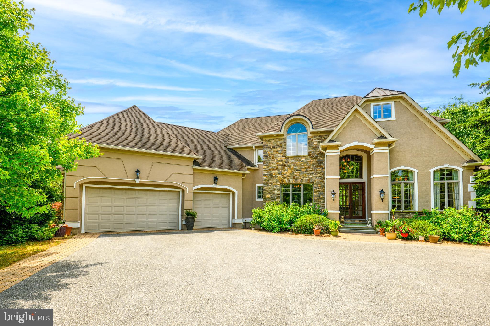 COMING SOON June 25, 2026 * OPEN HOUSE SATURDAY JUNE 27TH 12-2PM * Nestled on a private two acre lot in the highly regarded Saucon Valley School District, this exceptional custom built center hall colonial was originally constructed as the builder’s model home and showcases a level of craftsmanship, attention to detail, and quality rarely found in today’s market.

A grand two story foyer with an open staircase welcomes you into a home distinguished by extensive custom millwork, impressive trim, solid doors, and beautiful inlaid Brazilian hardwood flooring. The dramatic two story family room features a striking coffered ceiling and serves as the centerpiece of the home. Elegant entertaining spaces include a formal dining room with tray ceiling and refined style elements throughout.

The gourmet kitchen is designed for both everyday living and entertaining, offering custom cabinetry, granite center island, Viking and Bosch appliances including newer refrigerator and dishwasher, and abundant workspace. French doors open from the kitchen into the magnificent two story family room, creating a distinctive architectural feature seldom found in newer homes.

The first floor primary suite is a luxurious private retreat featuring a spacious sitting room, two sided fireplace, large walk-in closet, and a beautifully appointed primary bath.

Overlooking the open foyer, the second floor office/den provides the perfect setting for working from home, reading, or relaxing.  Two spacious bedrooms are found  upstairs as well.

The finished walkout lower level adds more than 1,400 square feet of living space and is ideal for entertaining. Highlights include a large family room with wet bar and gas fireplace, exercise room, private bedroom, and full bath. Direct access to the patio and private backyard setting creates a seamless connection between indoor and outdoor living.

Additional features include a three car garage and two new Bosch high efficiency heat pump systems installed in 2026, complemented by propane backup heat for year round comfort and efficiency.

Thoughtfully designed with timeless quality and European inspired design, this remarkable residence combines luxury, comfort, and enduring craftsmanship in one of the Lehigh Valley’s most desirable locations.